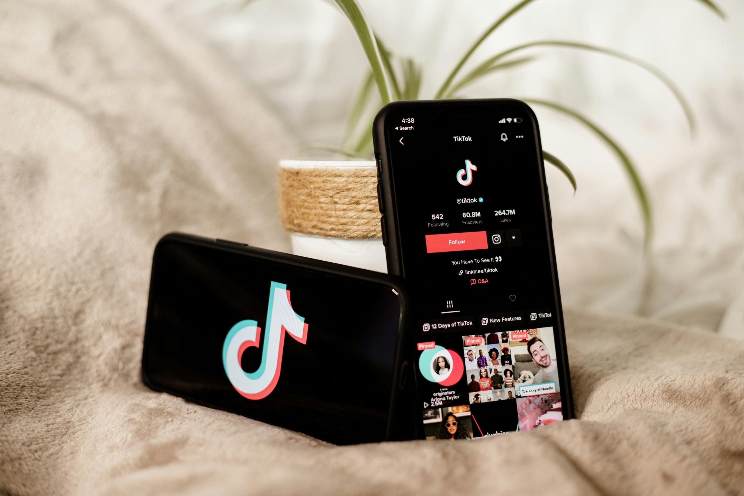 two phones with tiktok app open on screens