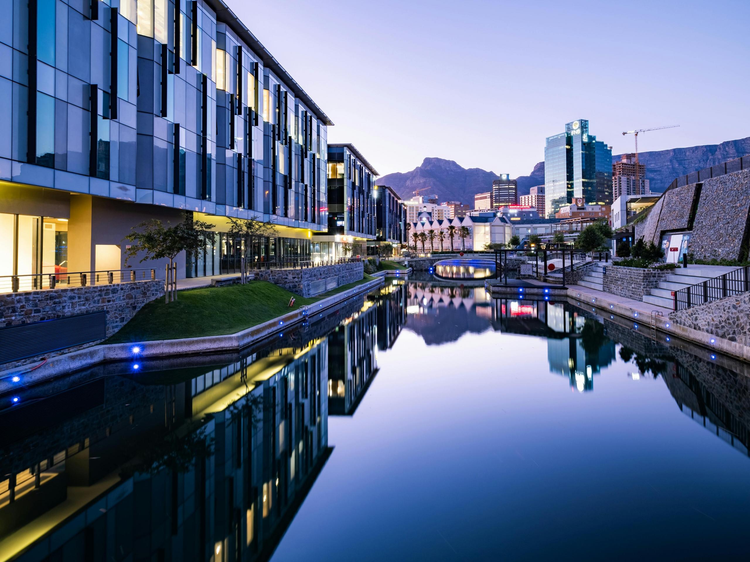 Body Of Water Between Buildings with table mountain in the background