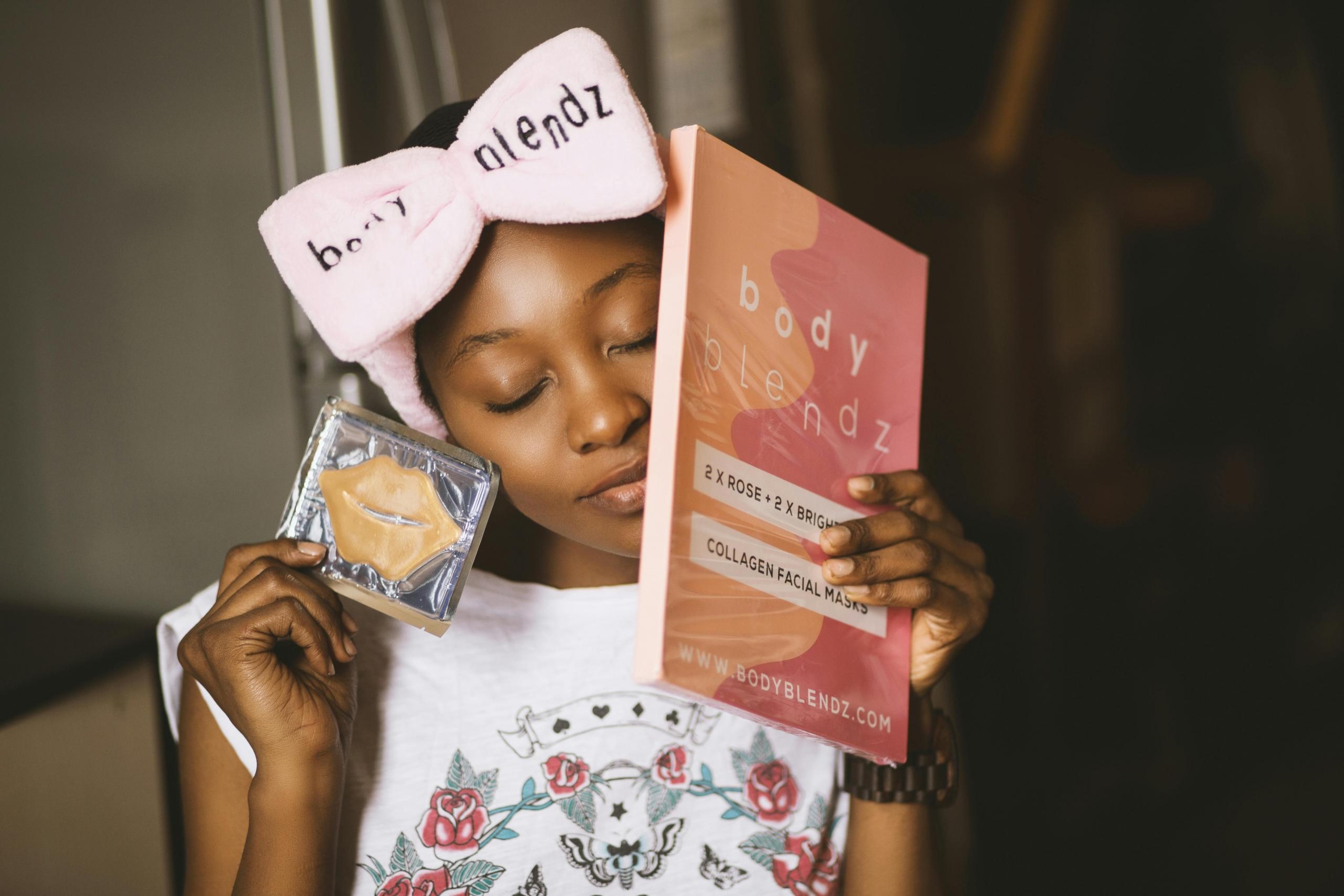 influencer wearing branded headband holding skincare products
