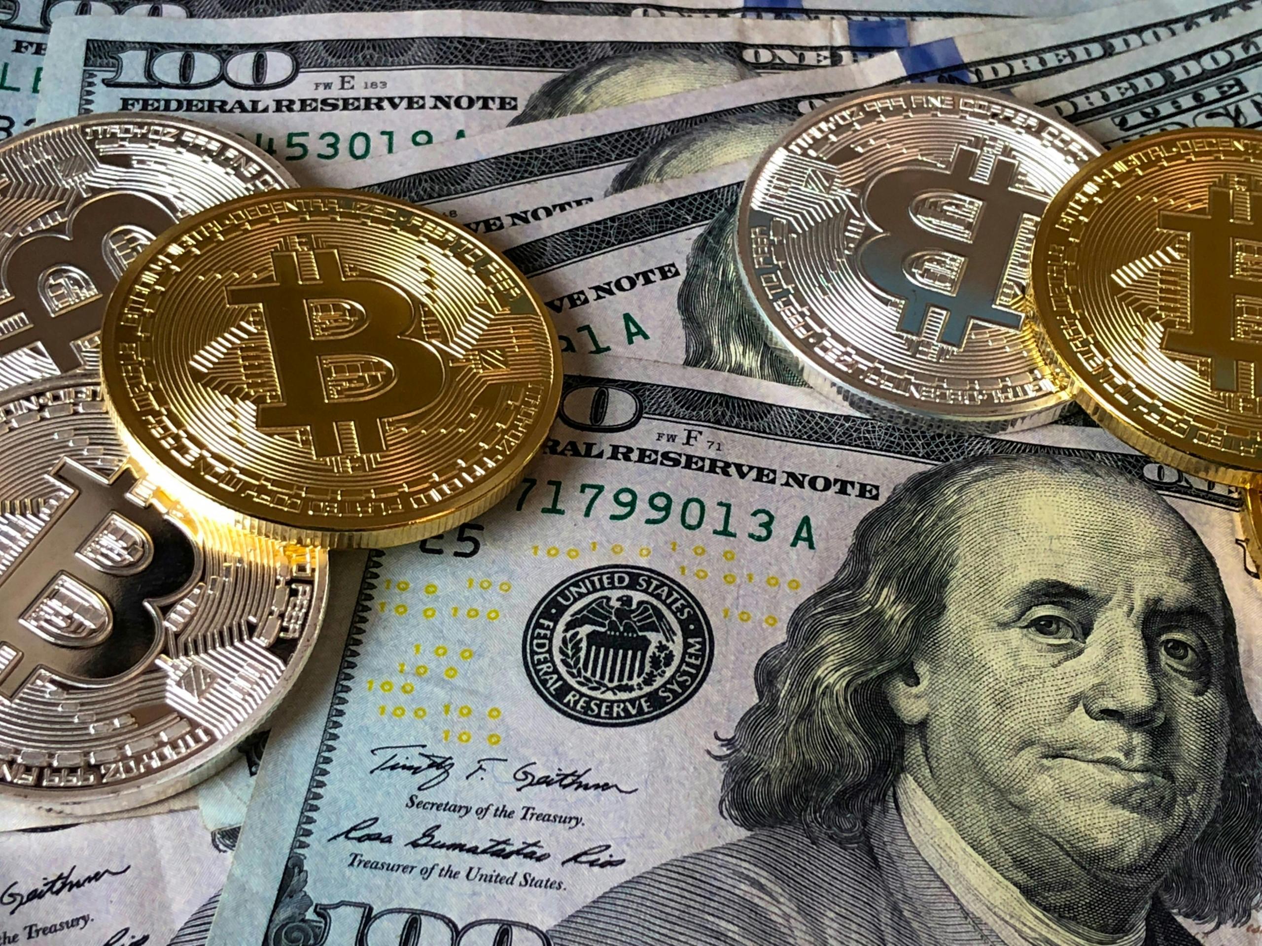 dollar notes and cryptocurrency coins
