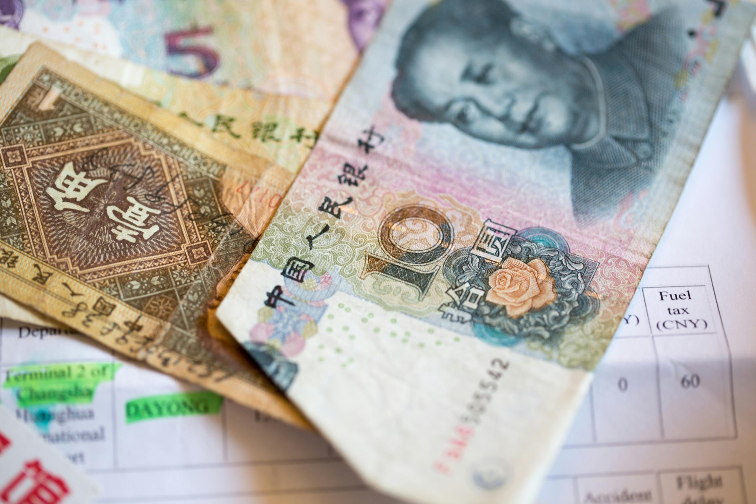 yuan banknotes spread out on top of paperwork