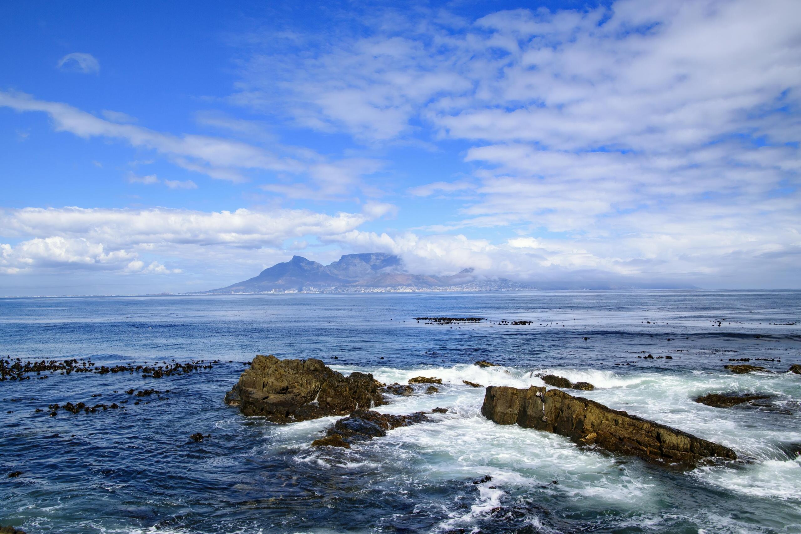 table mountain captured under blue sky with scattered clouds from blouberg