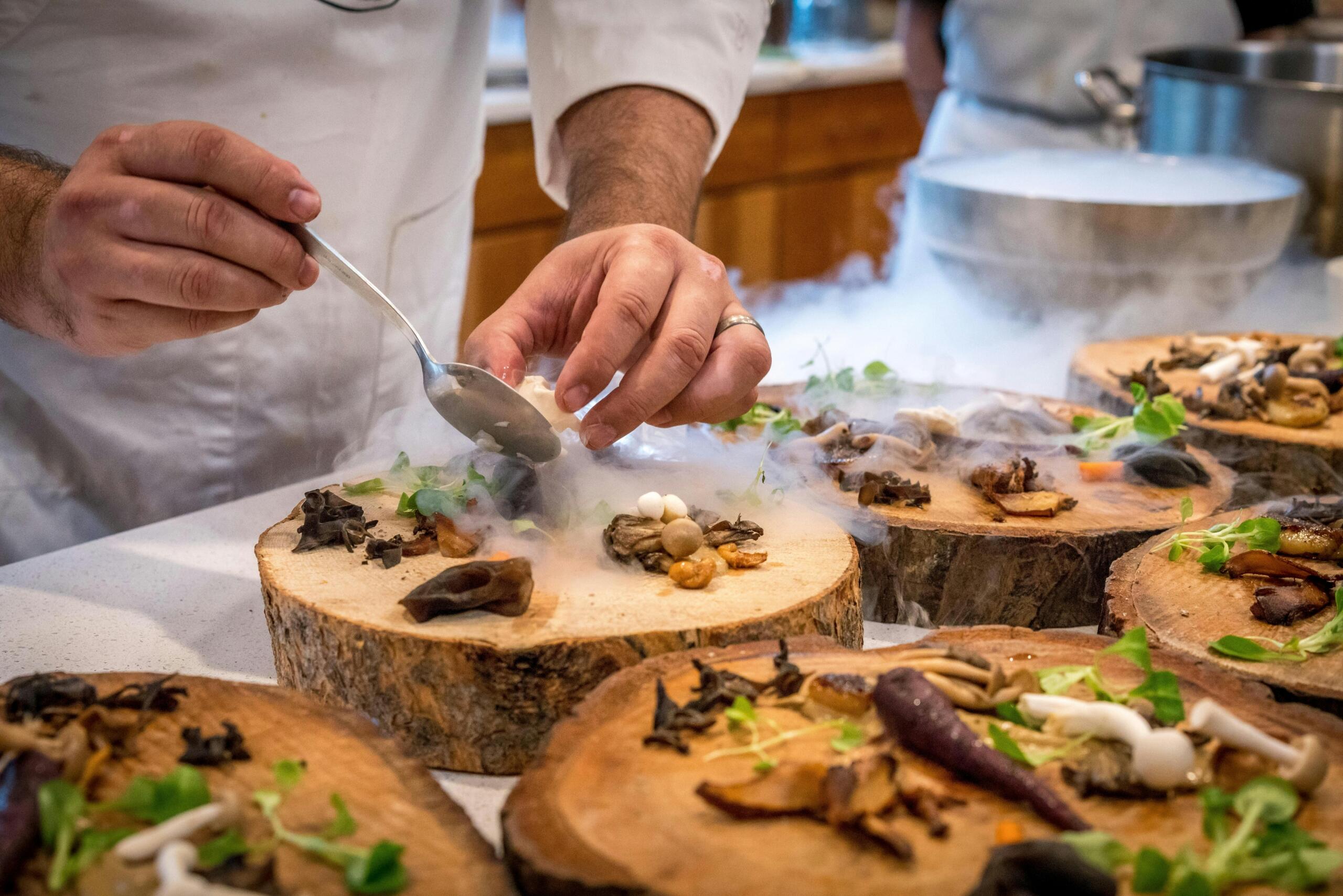 Chef Preparing Vegetable Dish on Tree Slabs and using liquid nitrogen