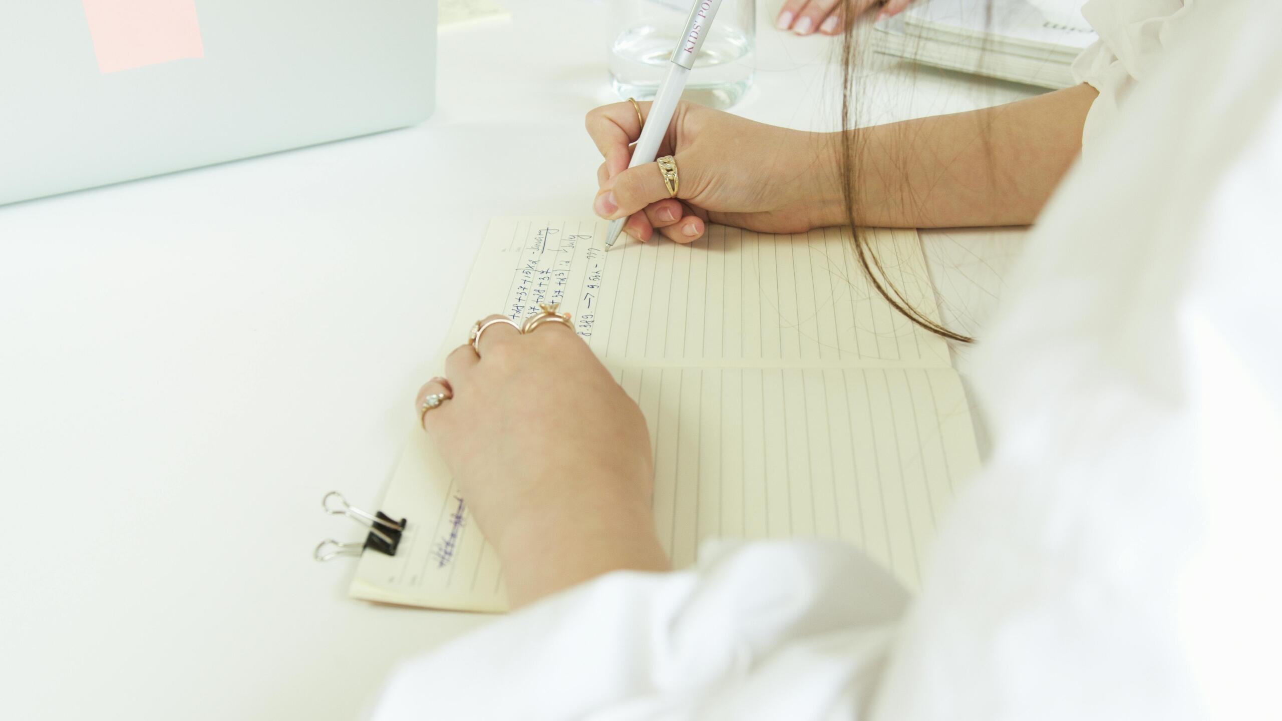 person writing in a notebook