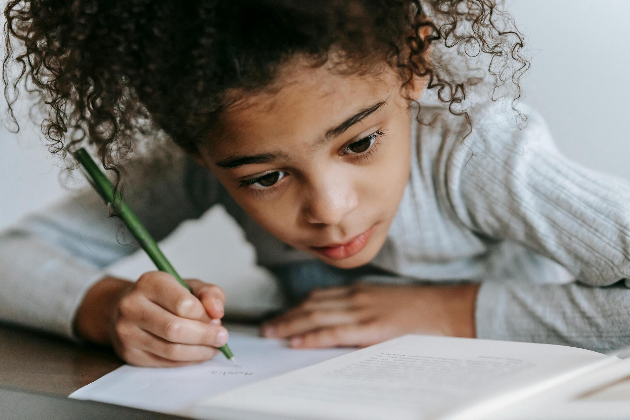 young girl writing in a notebook