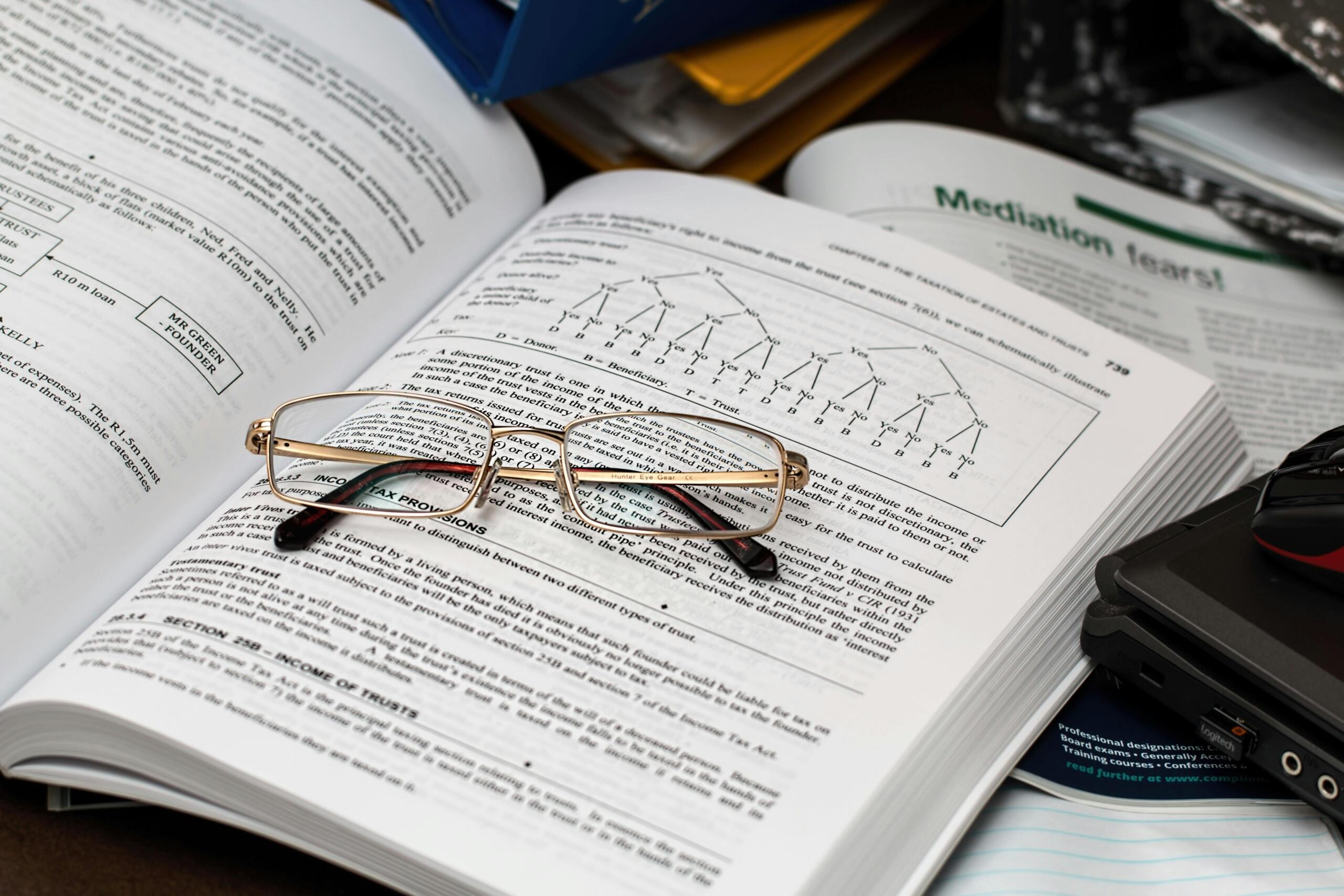 a pair of spectacles placed on an open finance book