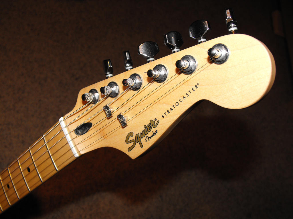 The headstock of a Fender electric guitar. 