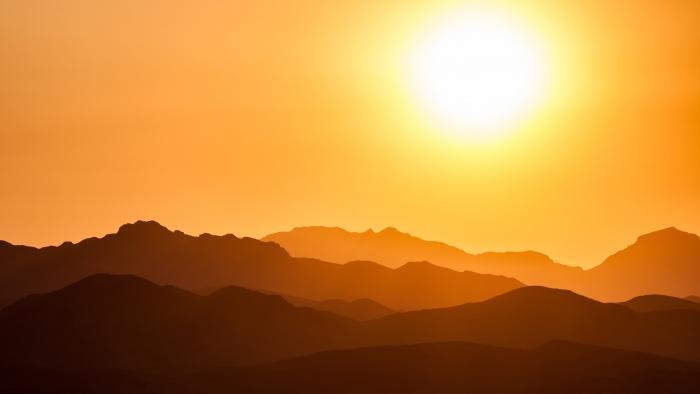 Sun rising over hills