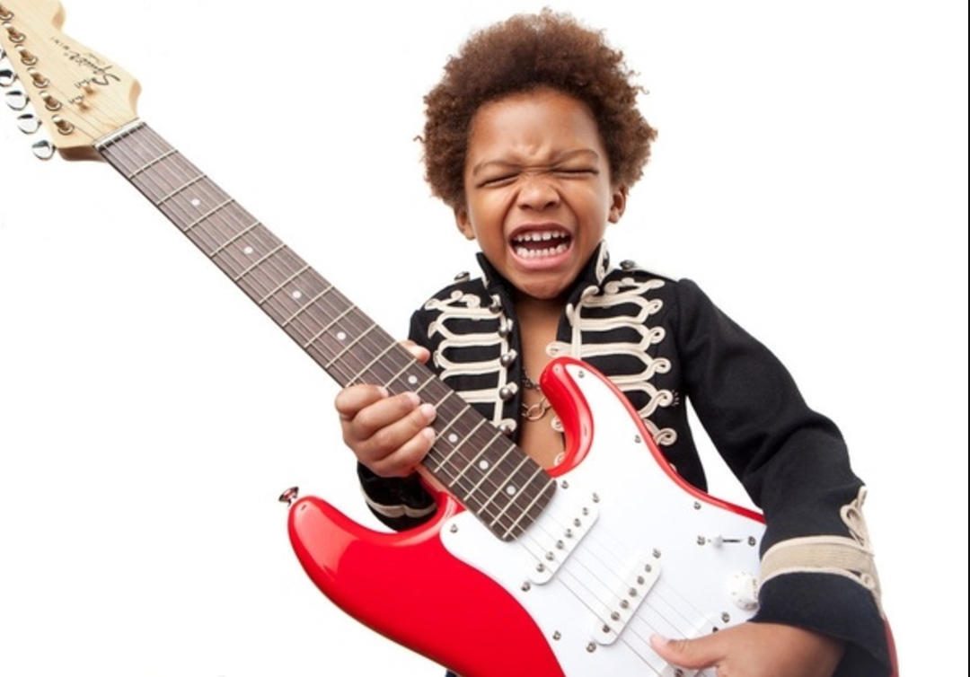 a child with an electric guitar