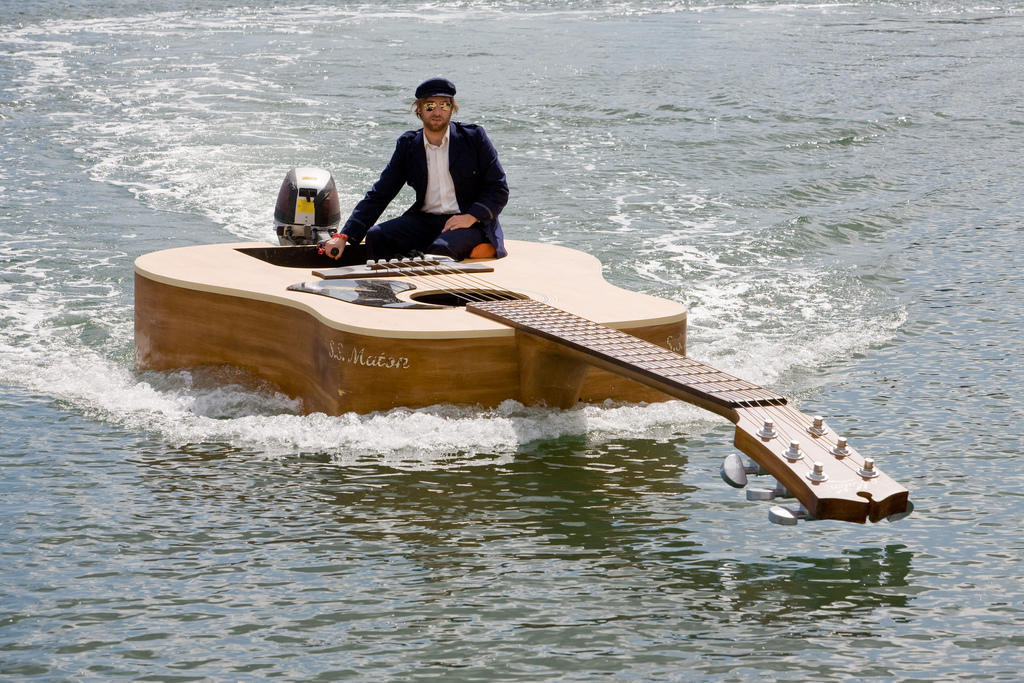 A man on a guitar-shaped boat.