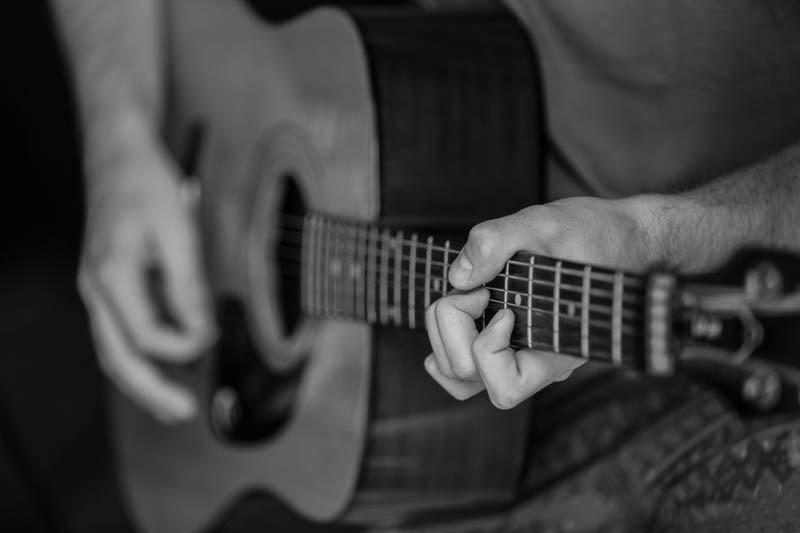 A man plays the acoustic guitar
