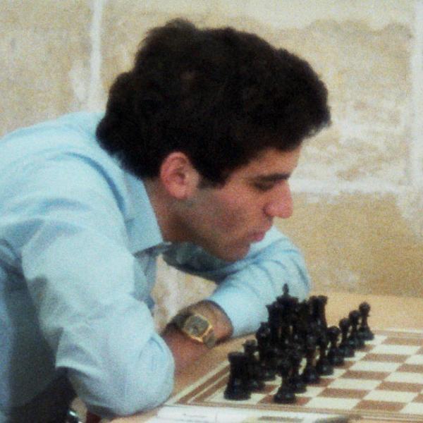 Kasparov examines a chessboard before his immortal game