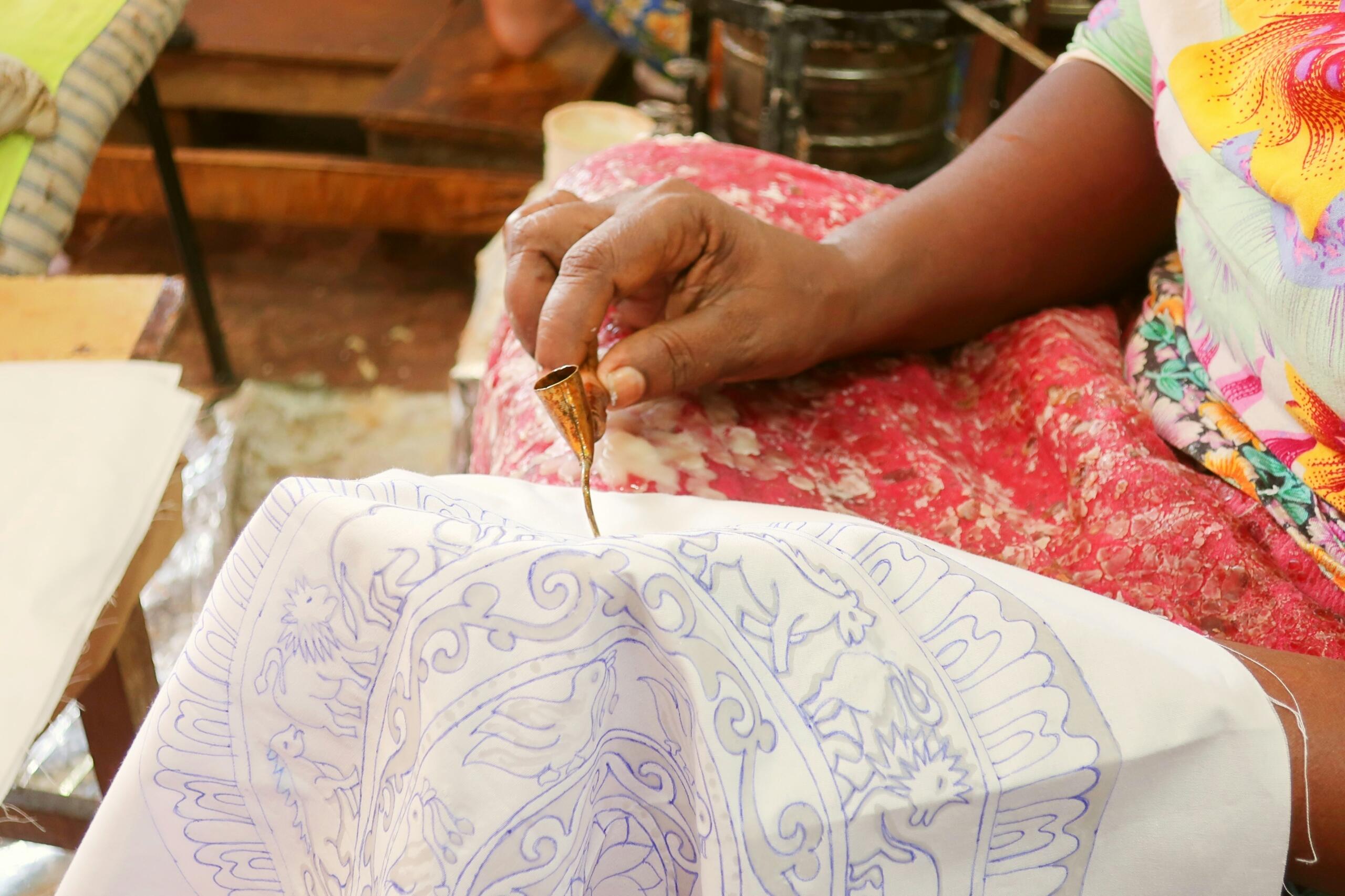An embroidery artist begins with a stitch.