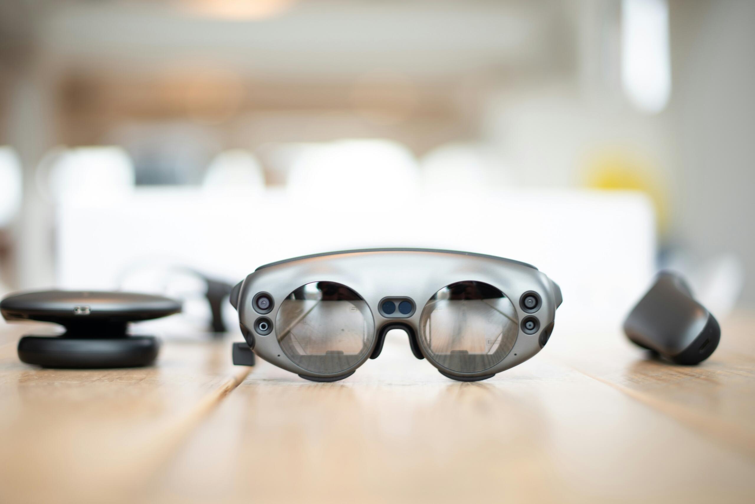 a pair of augmented reality smart glasses on a surface with a blurred background
