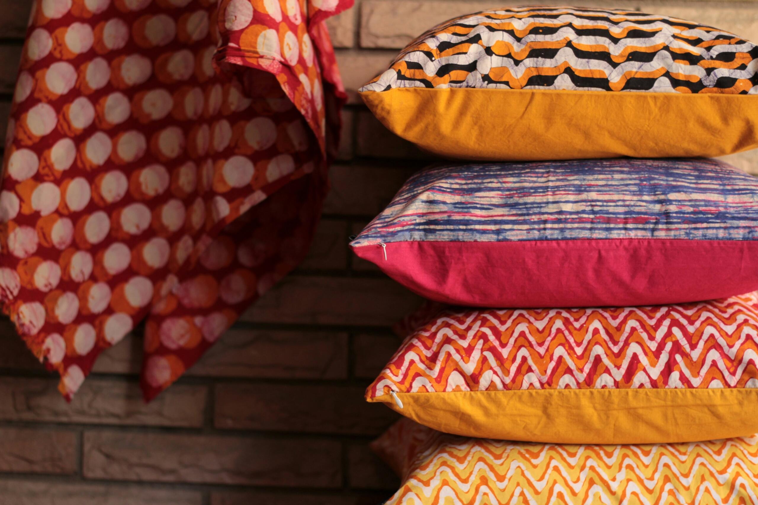 A stack of colourful scatter cushions.