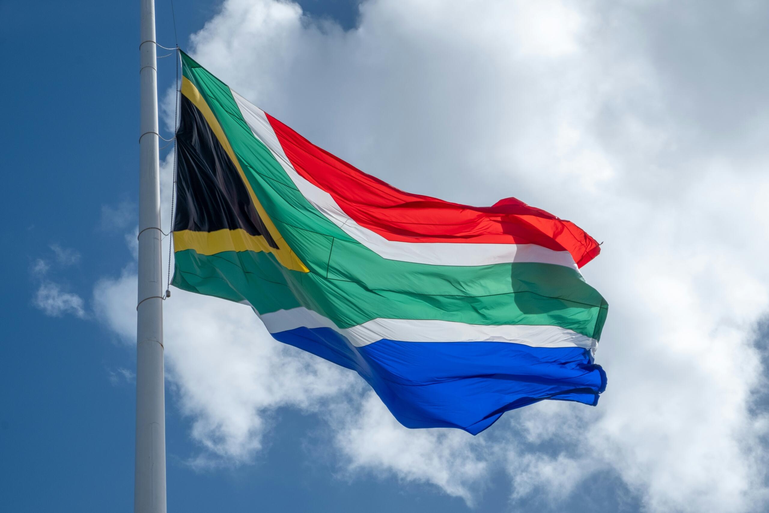 The South African Flag against a blue sky. 