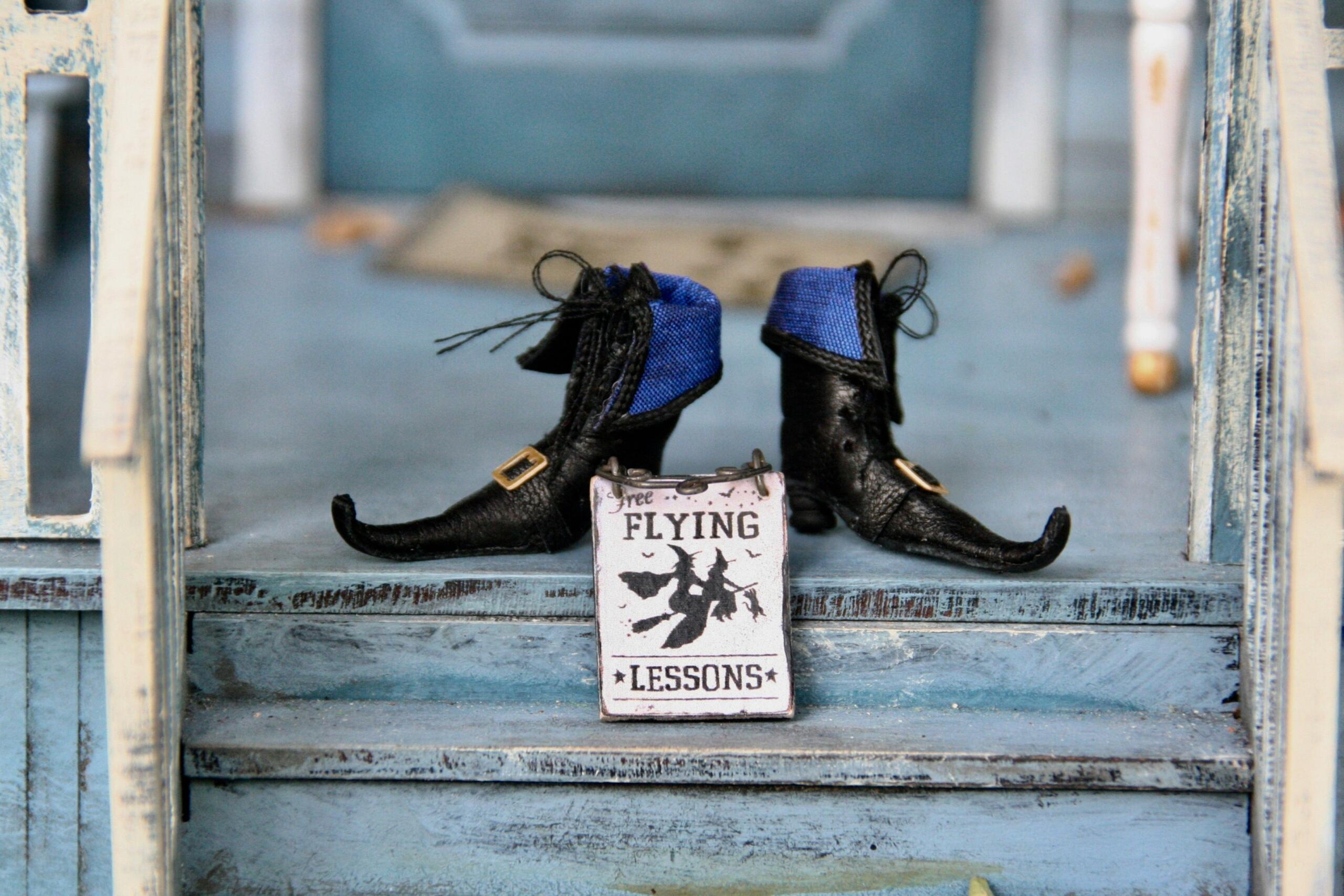 a piar of witches boots with a flying lessons sign placed on stairs leading to a porch