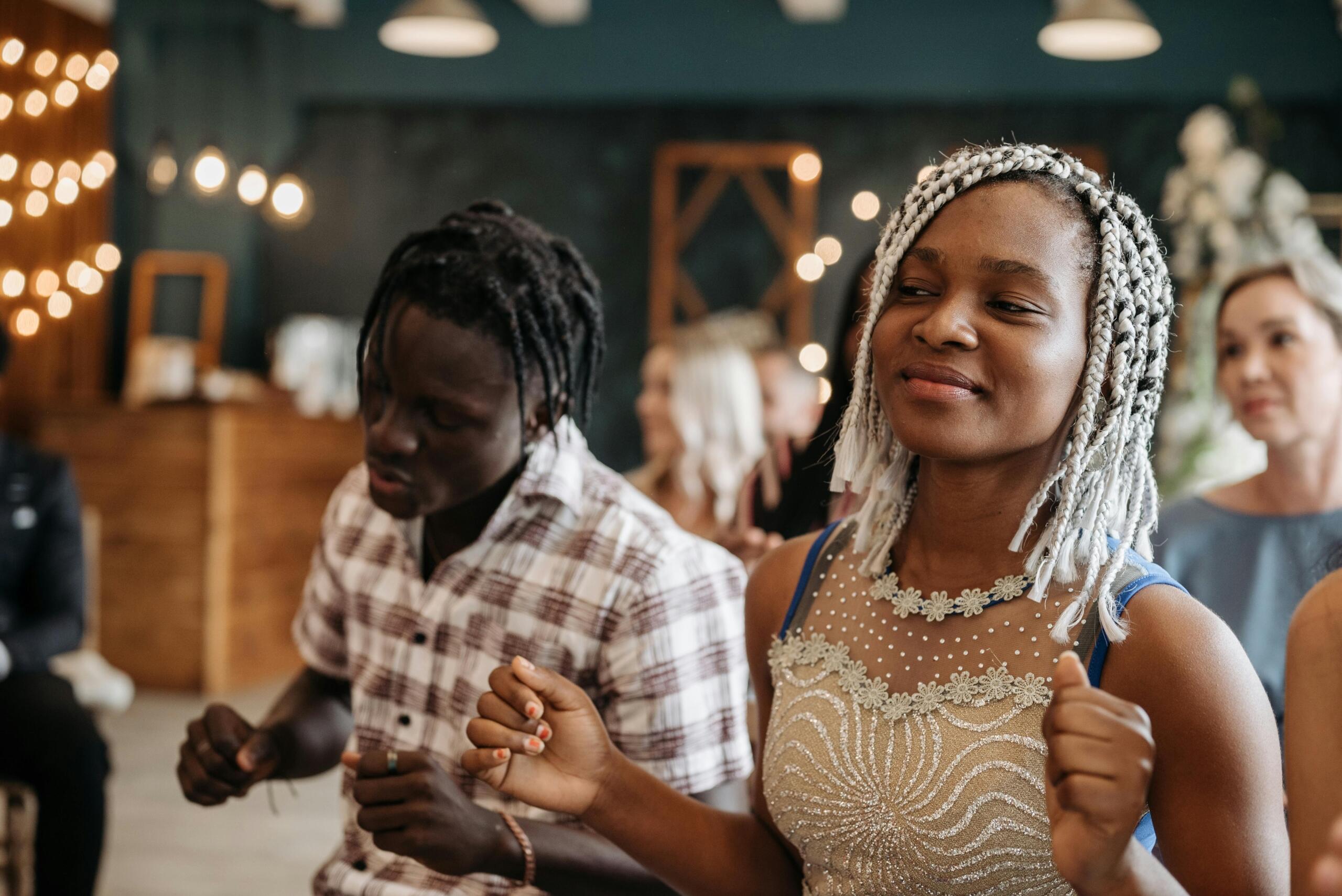 people sitting in a worship session with their eyes closed