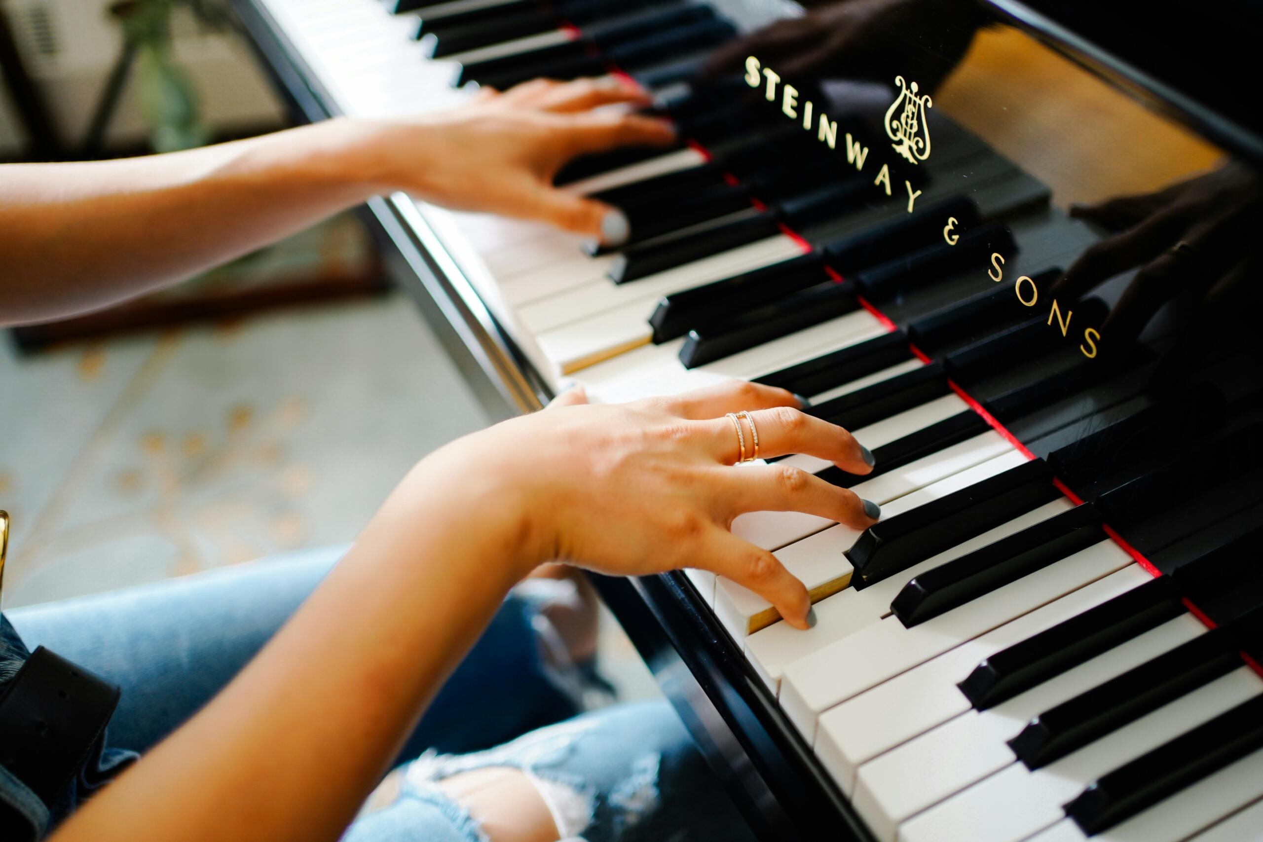 female pianists hands on piano keyboard