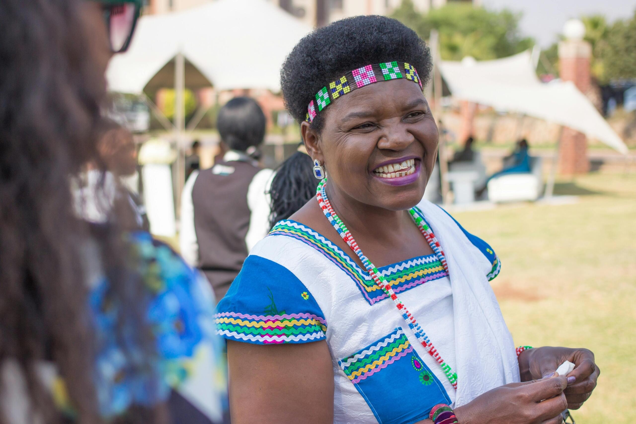 a woman wearing a traditional dress and beaded headband