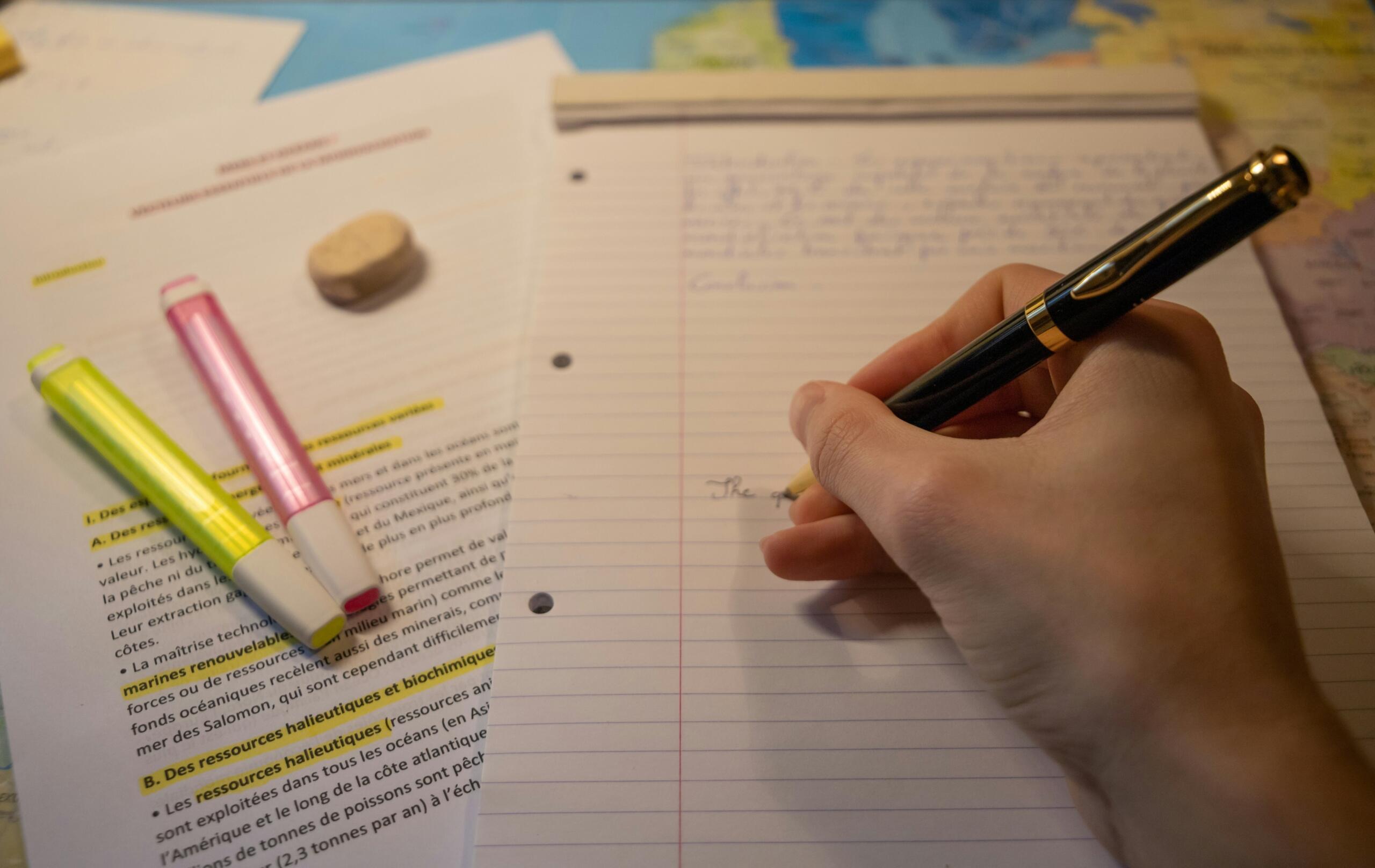 A student makes notes during a study session. 