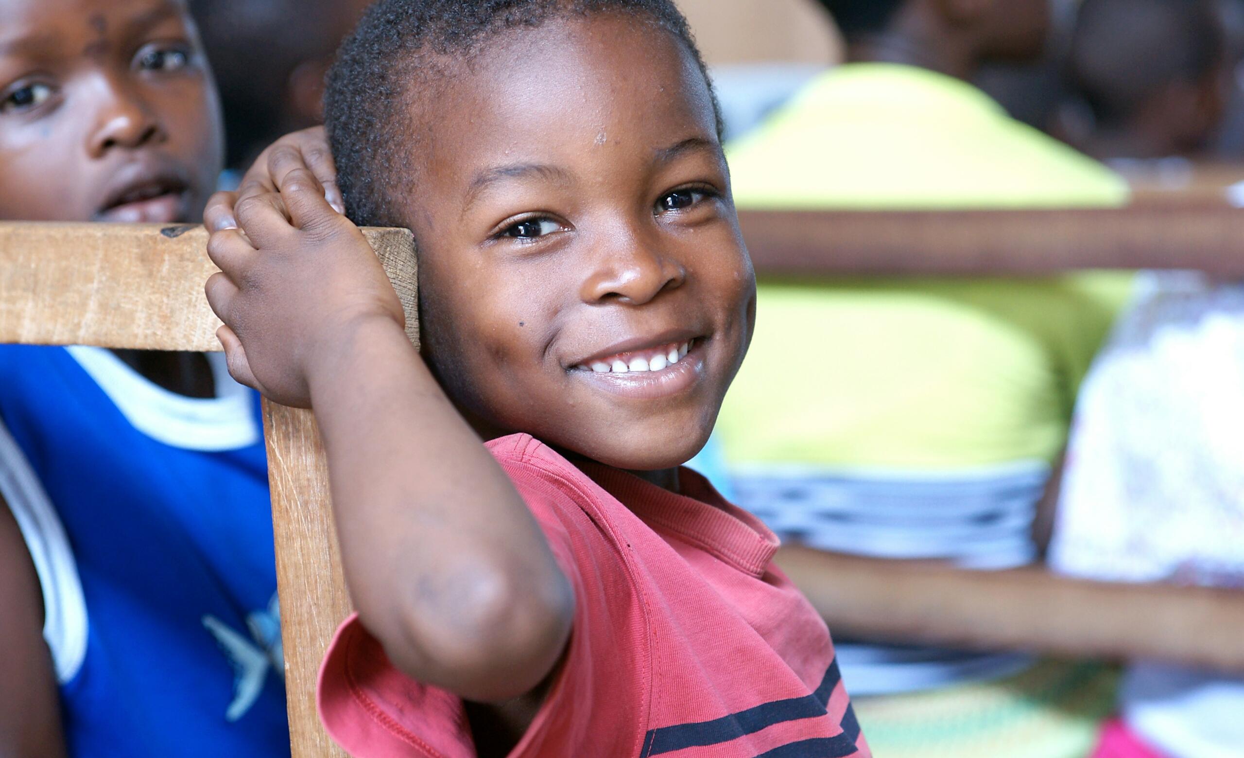 young boy turning to smile at the camera