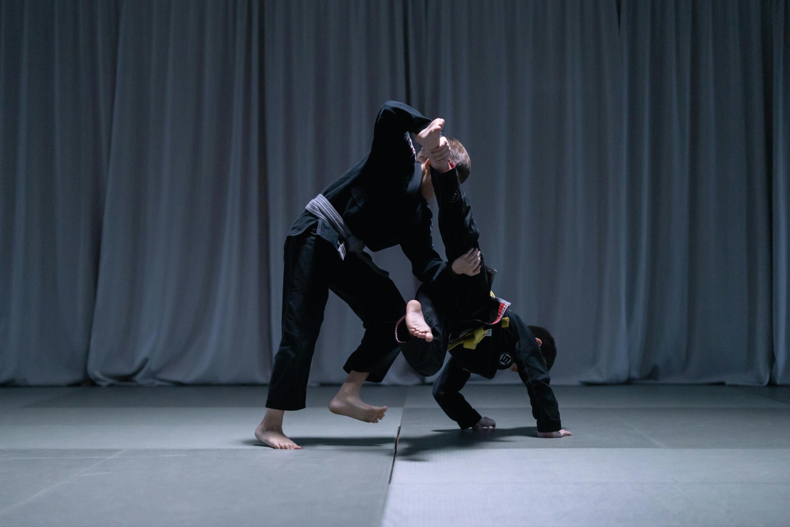 A grapple on a martial arts mat.