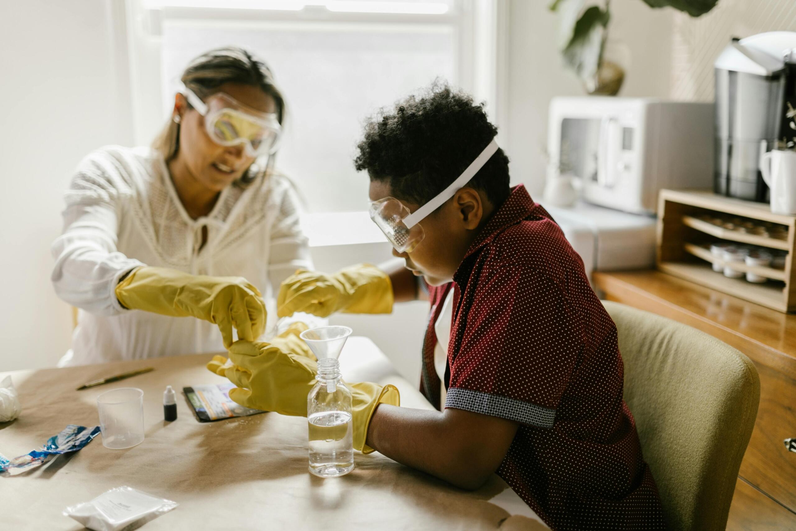 Science project partners in a lab wear protective eye wear.