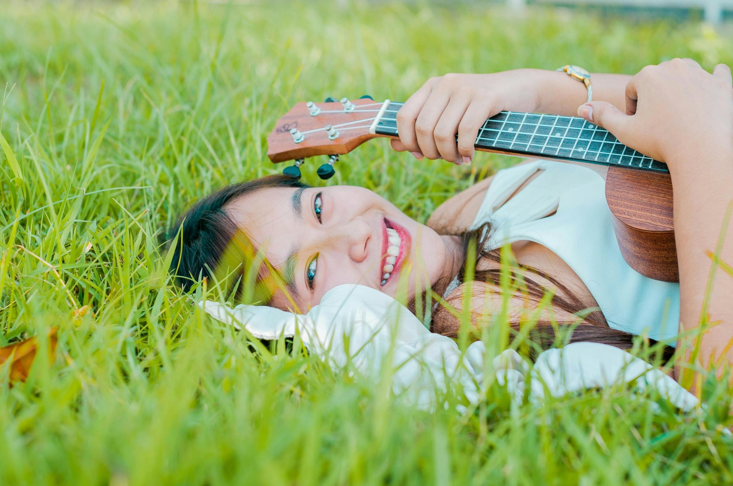 A happy guitar player in nature.