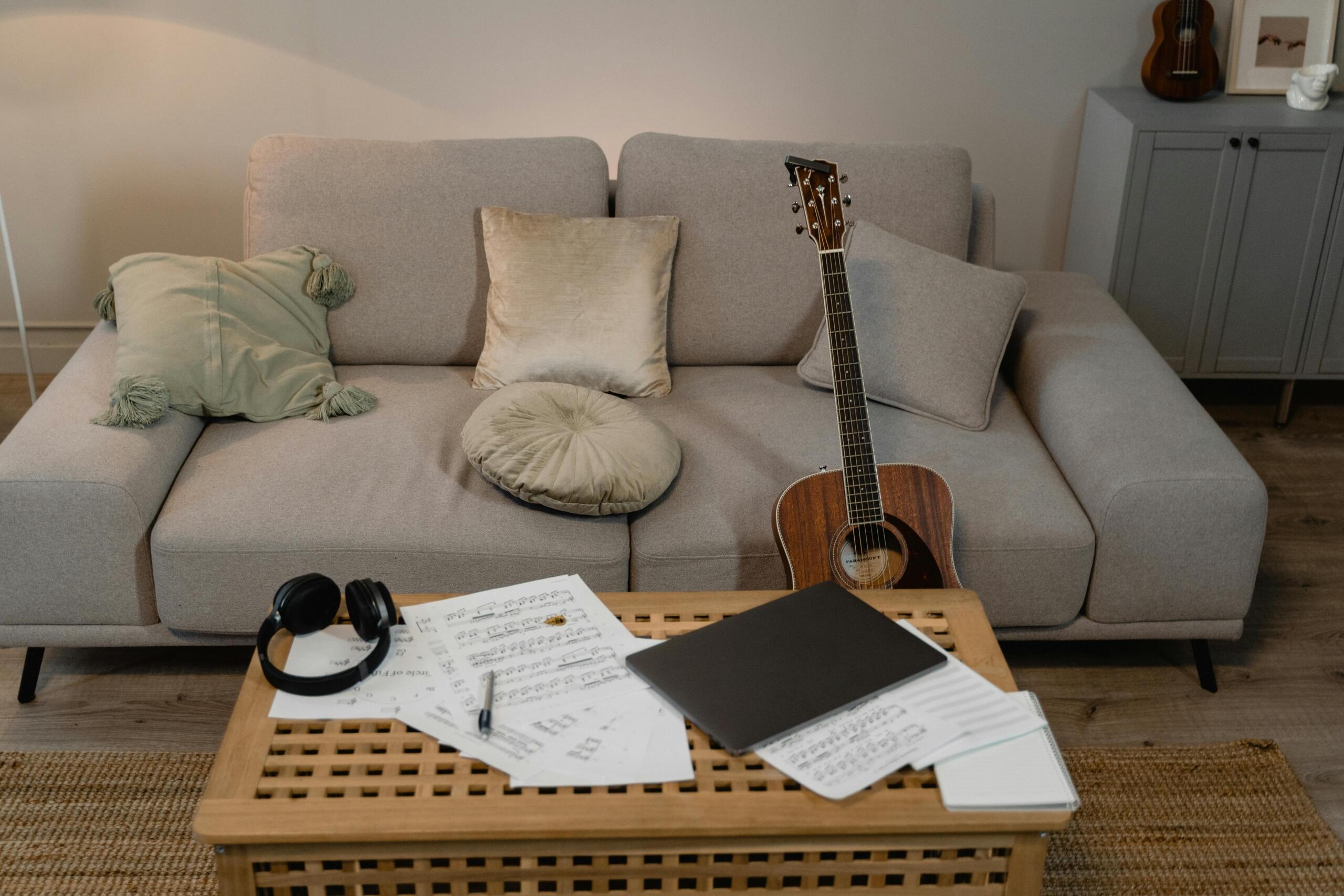 A guitar and notes in a living room.
