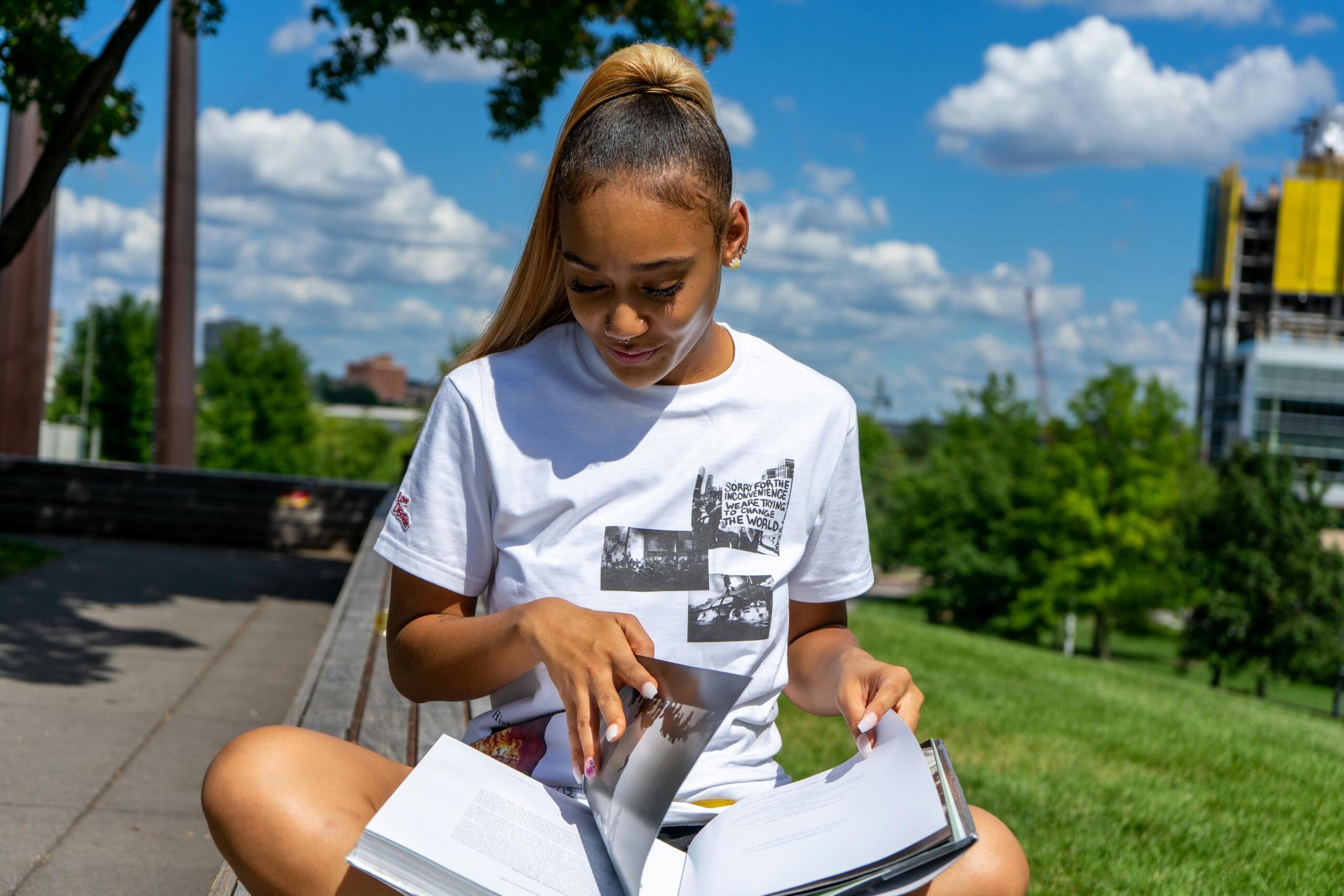 A young student studies outside. 