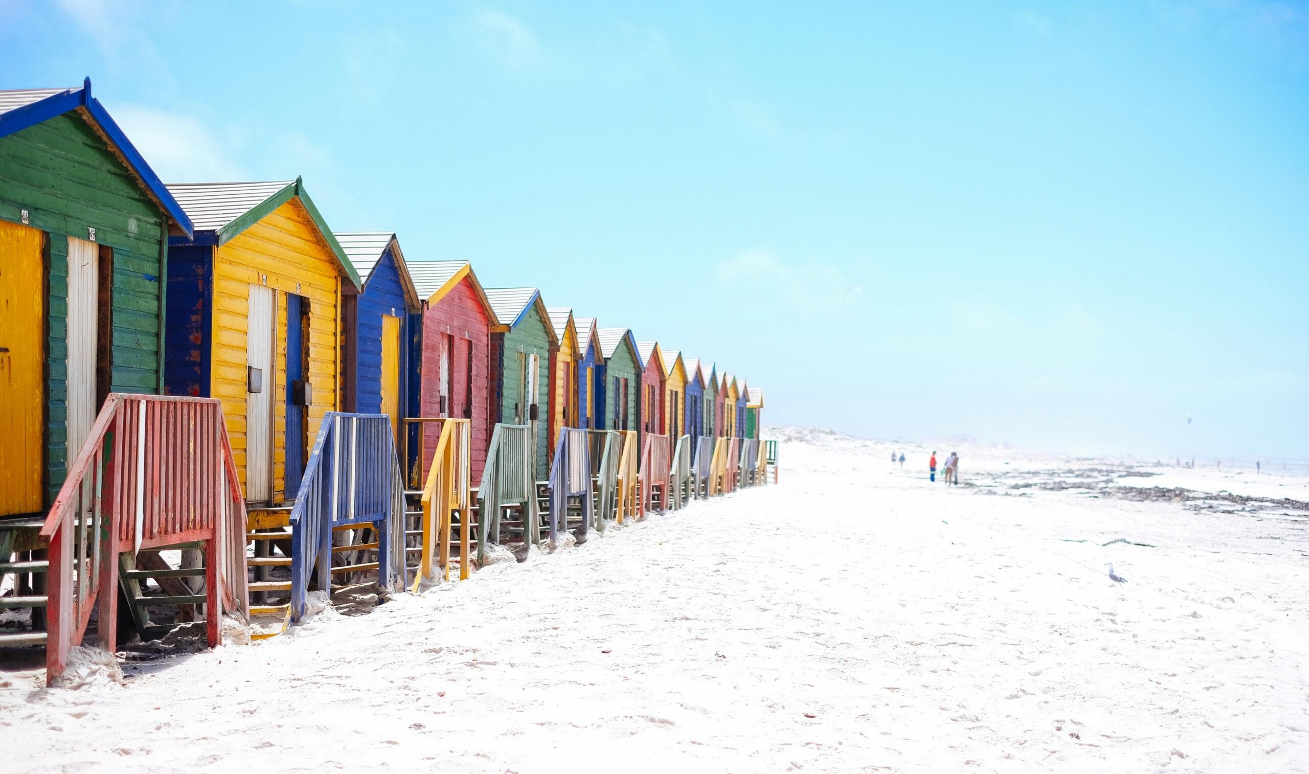 assorted-colour-beach-huts-on-white-sandy-beach-muizenberg-cape-town