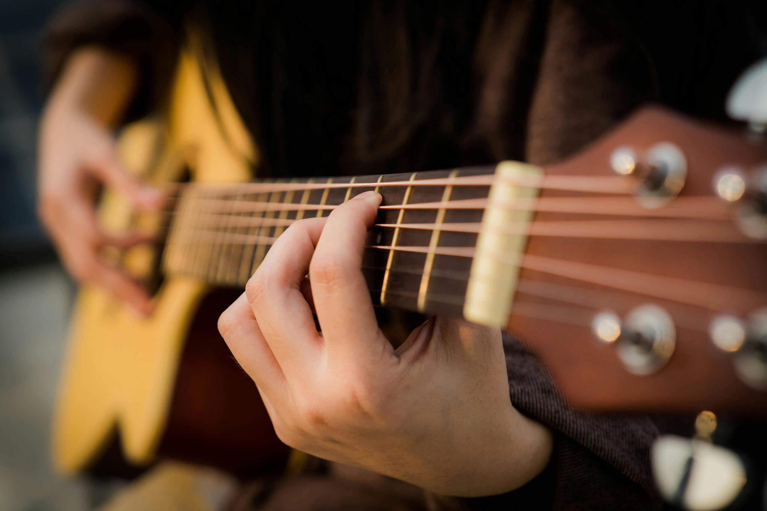 close up of guitar player's hands as he strums