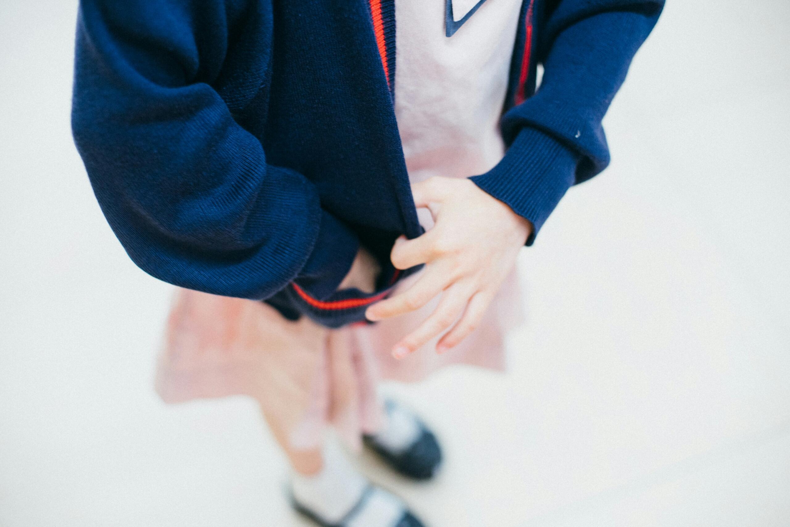An unusual angle of a child in school uniform. 