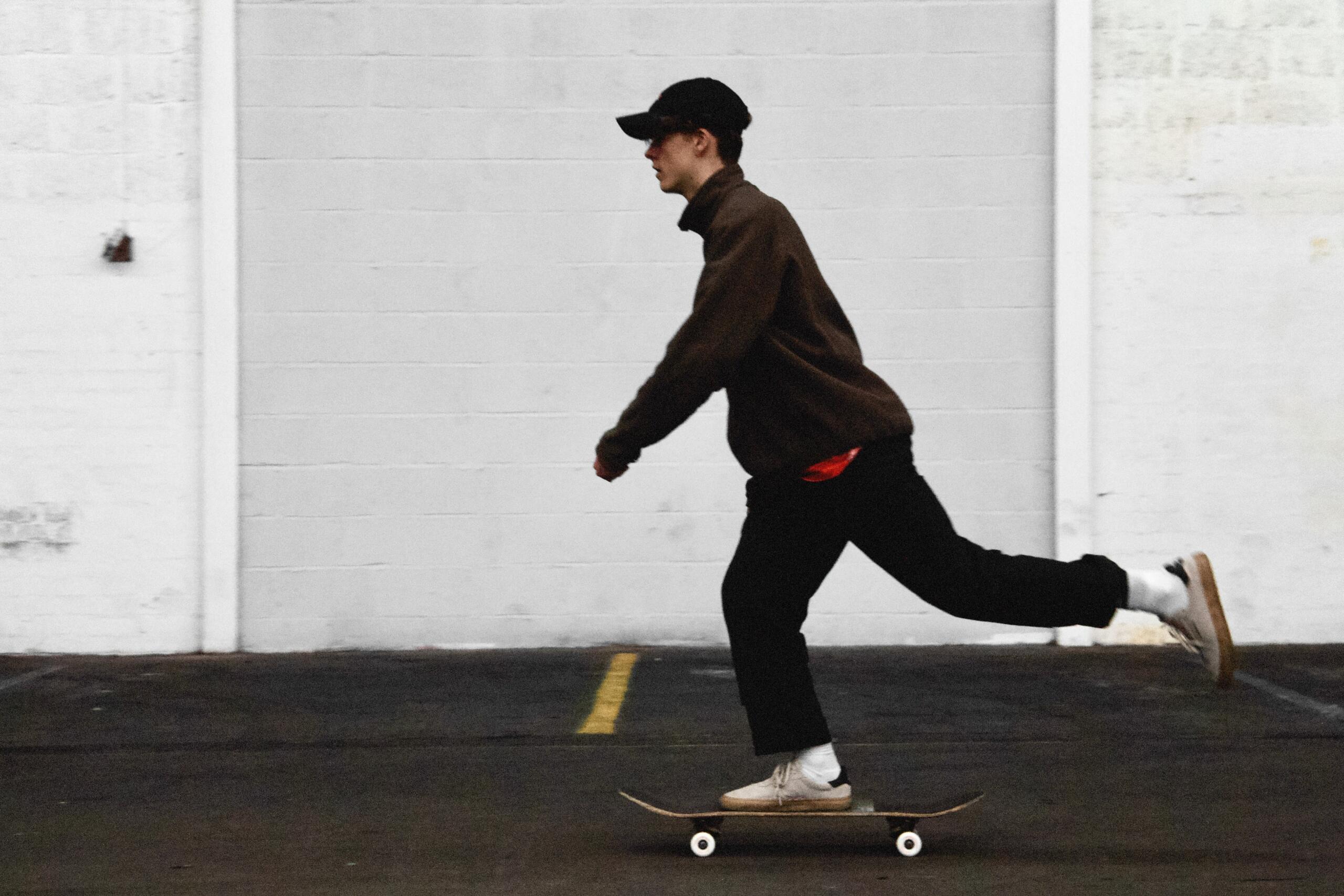 Boy with one foot on the skateboard and one in the air
