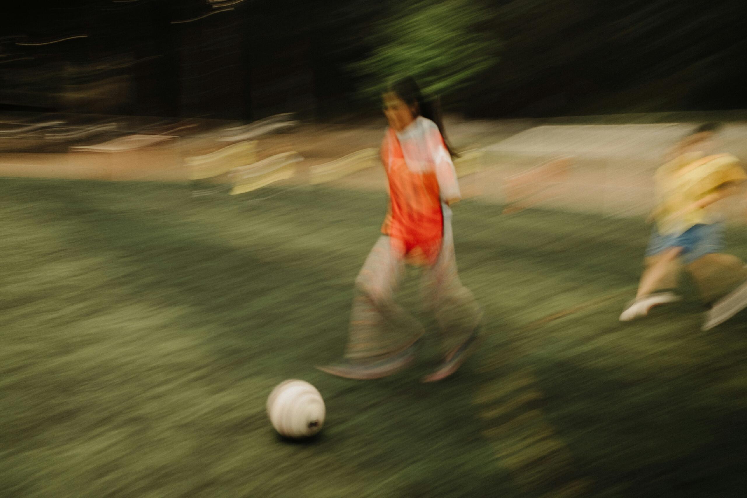 A blurred image of a soccer player.