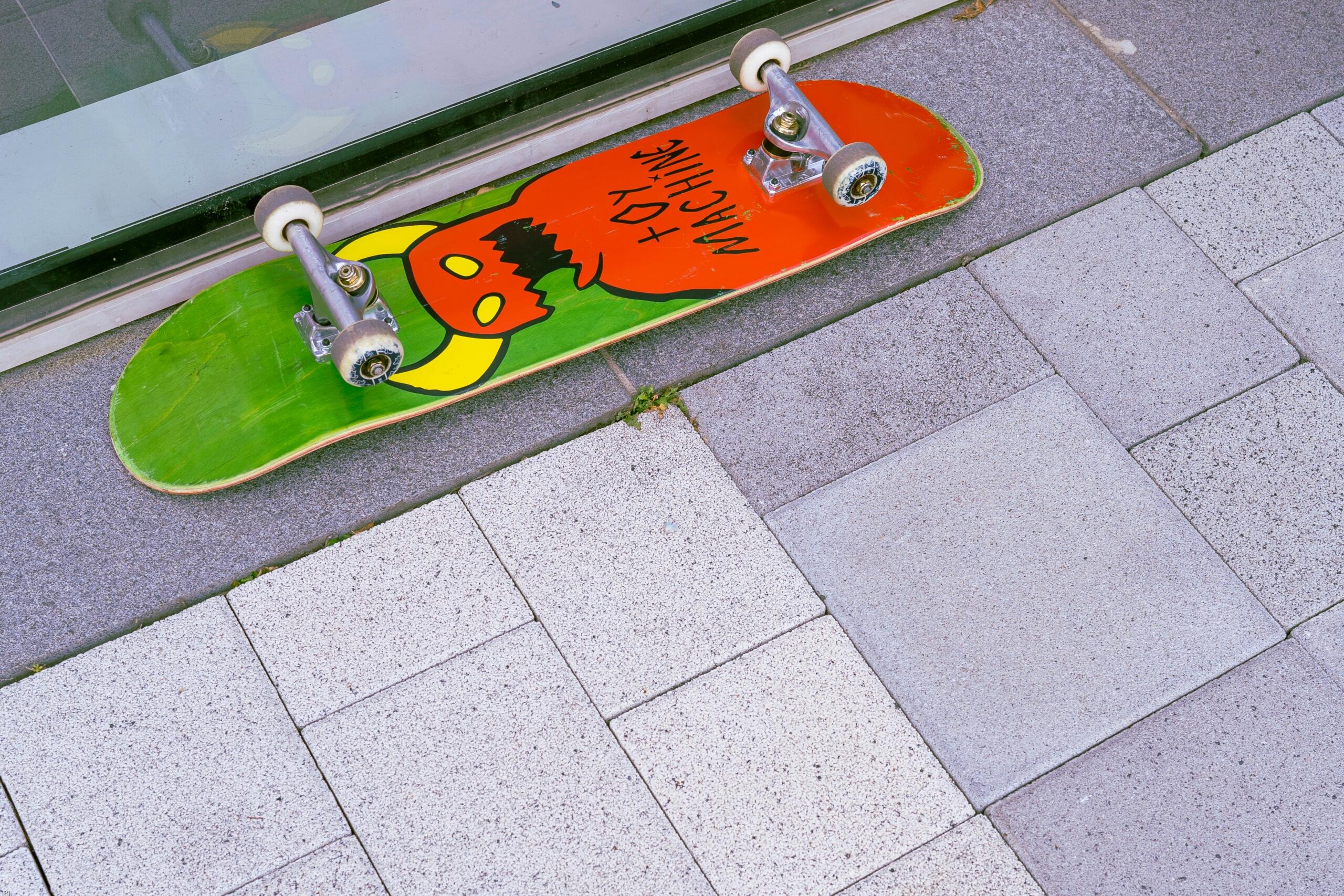 Upside down green and orange skateboard
