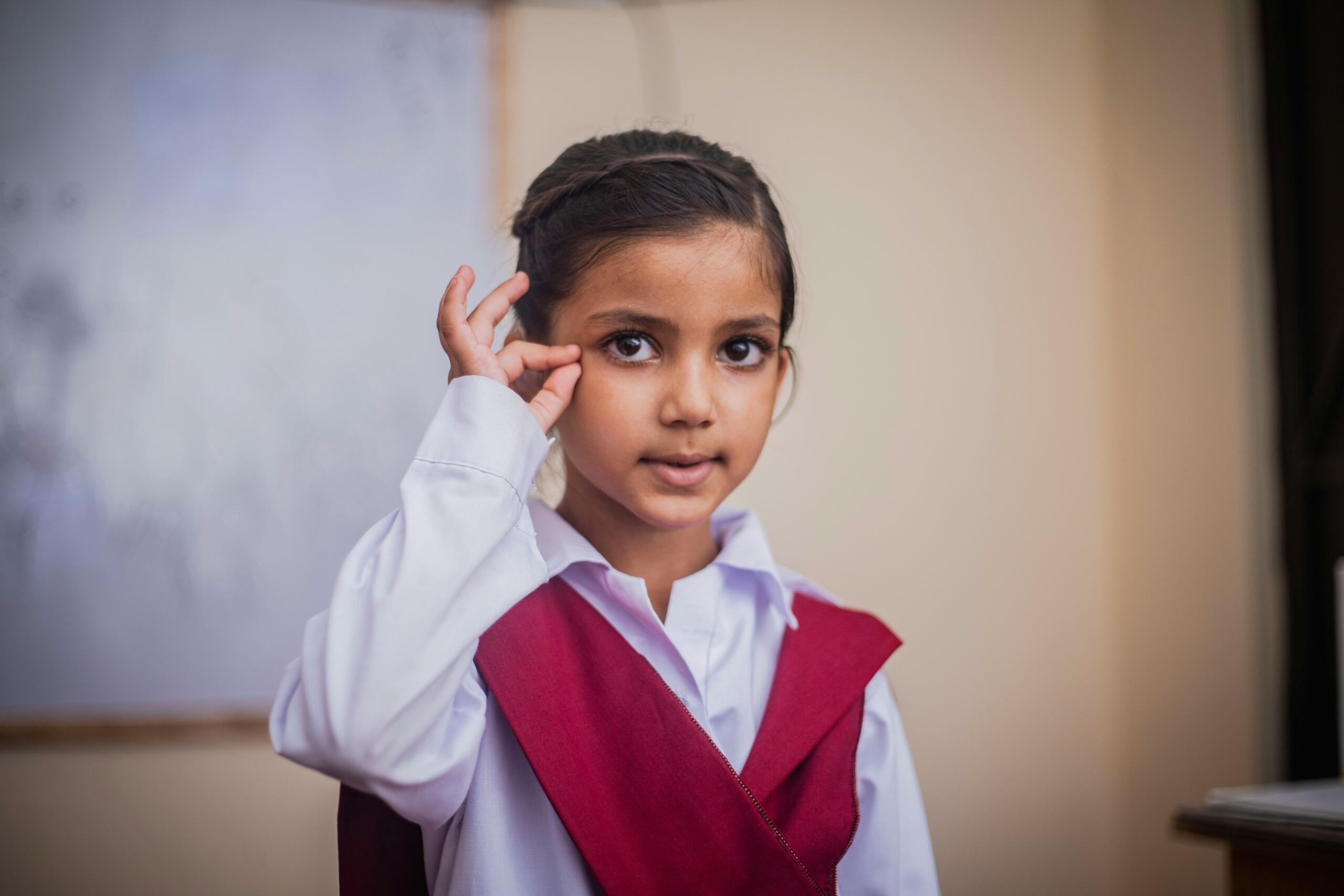An image of a school child using sign language.