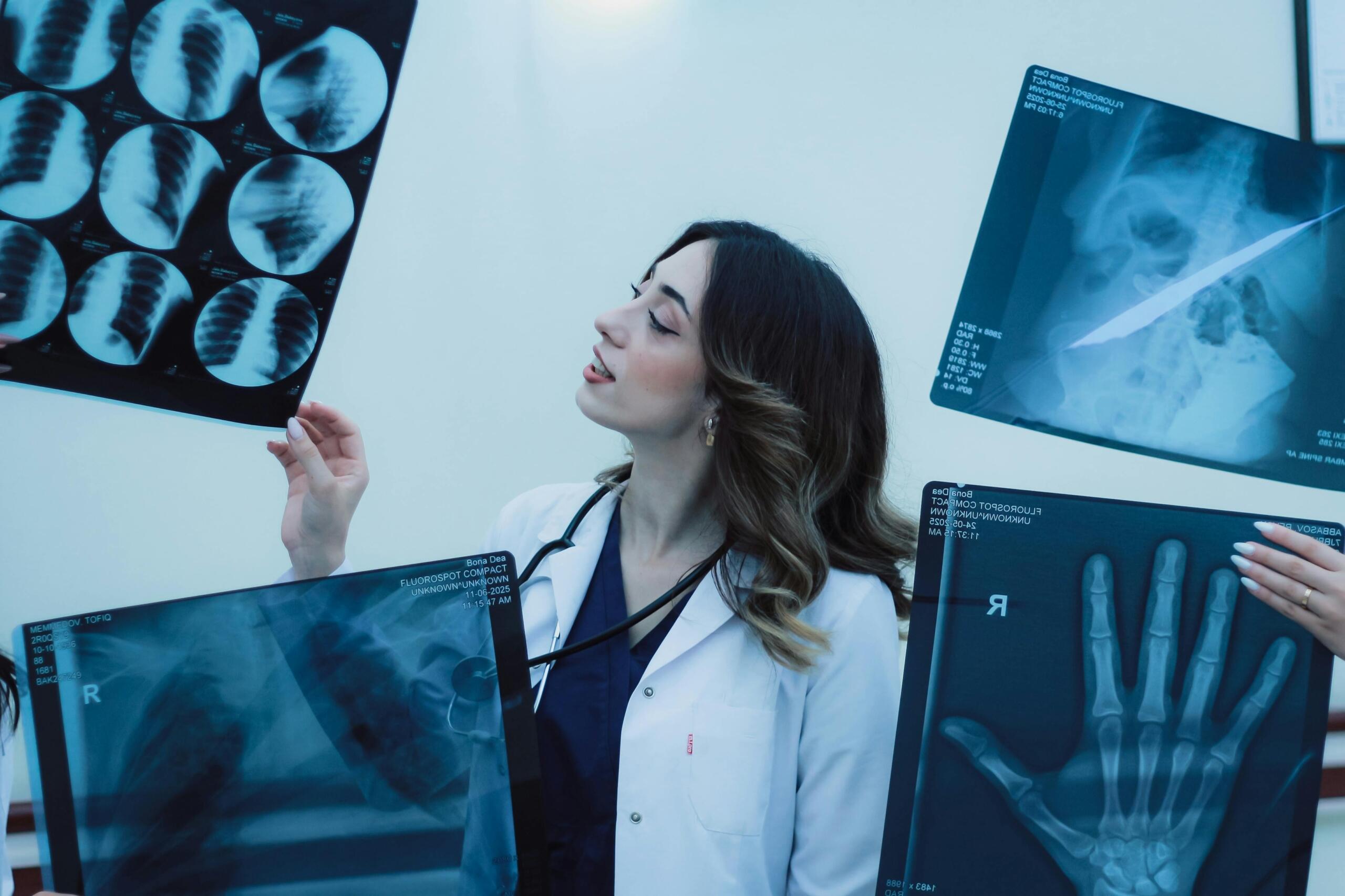 doctor wearing lab coat looking at x-rays