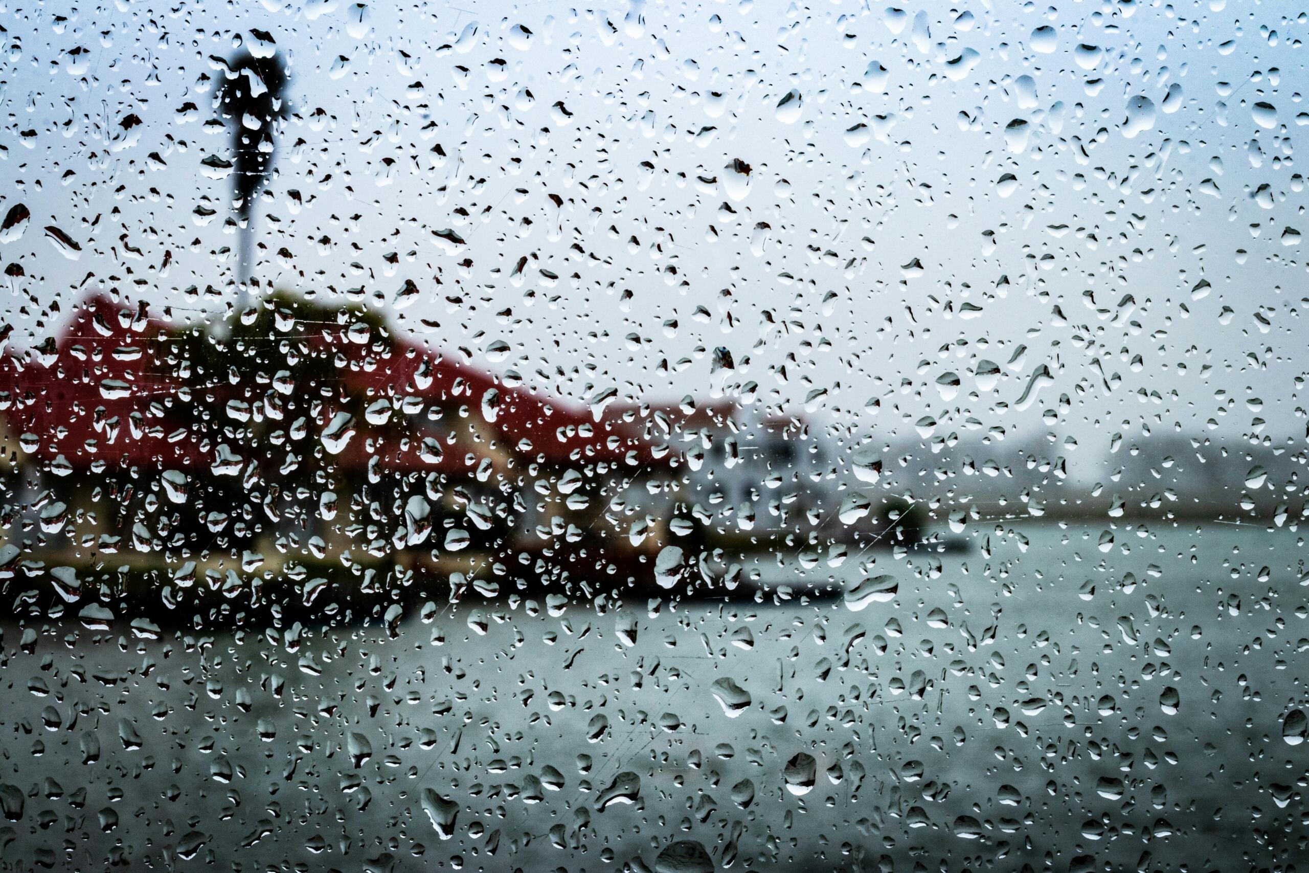 An image of rain drops on a windshield.