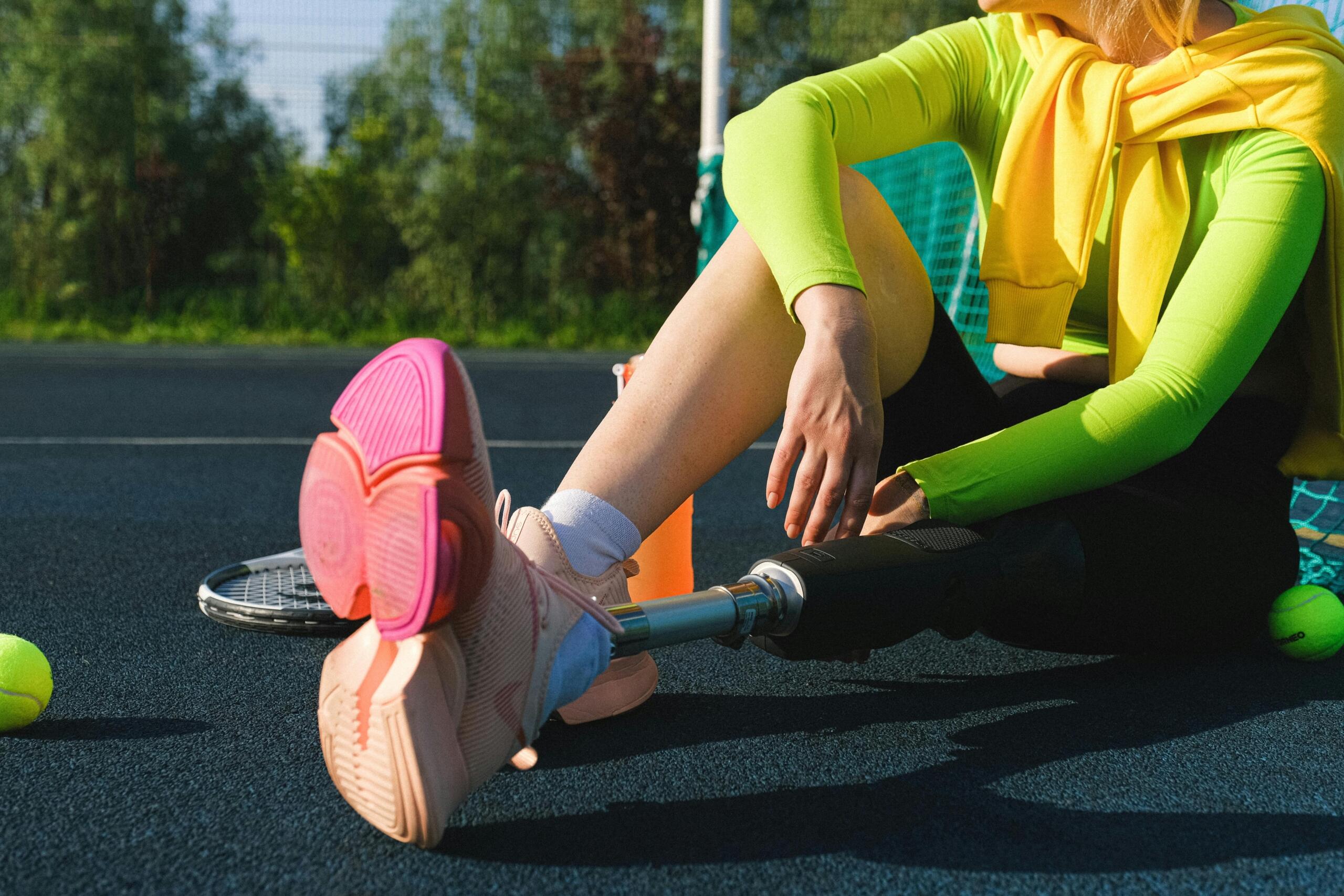 An image of a leg amputee warming up on a sports track. 