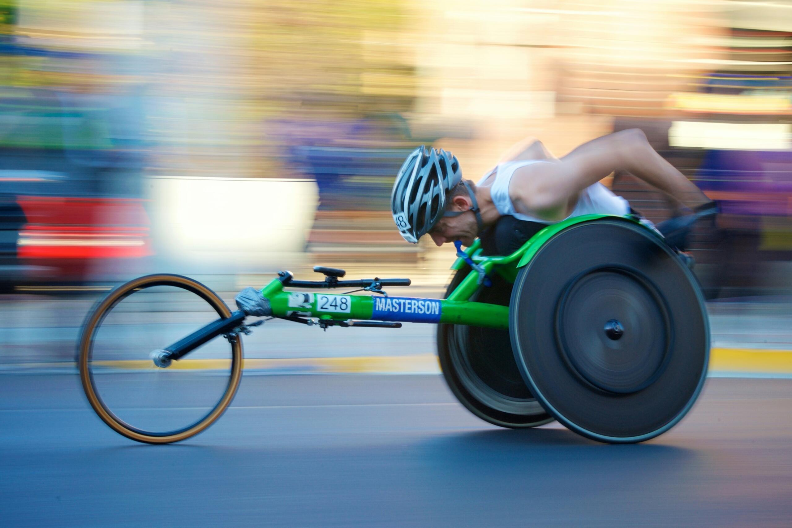An image of an adaptive cyclist at full speed. 