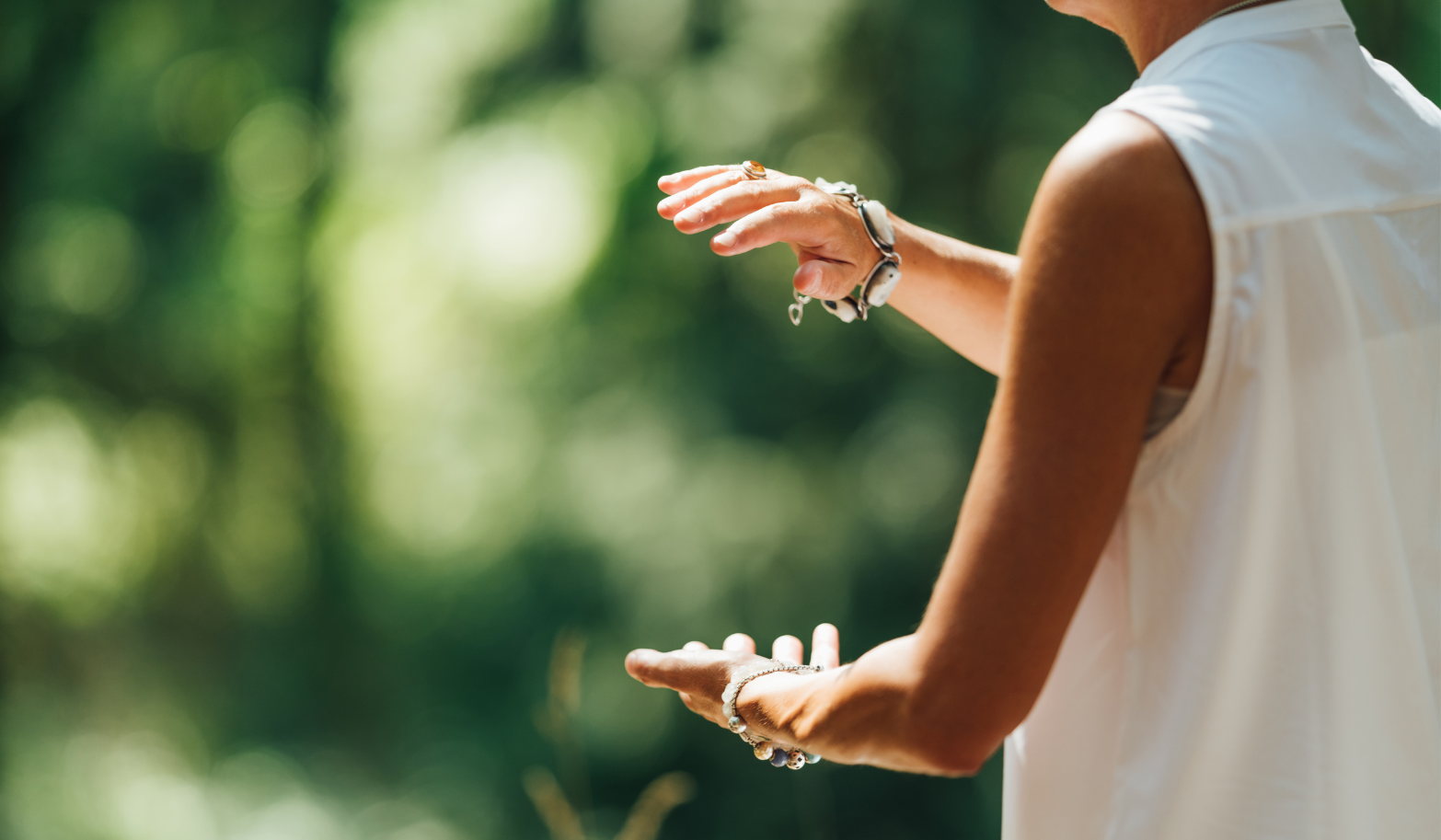 woman-in-white-sleeveless-top-standing-under-green-trees-during-daytime