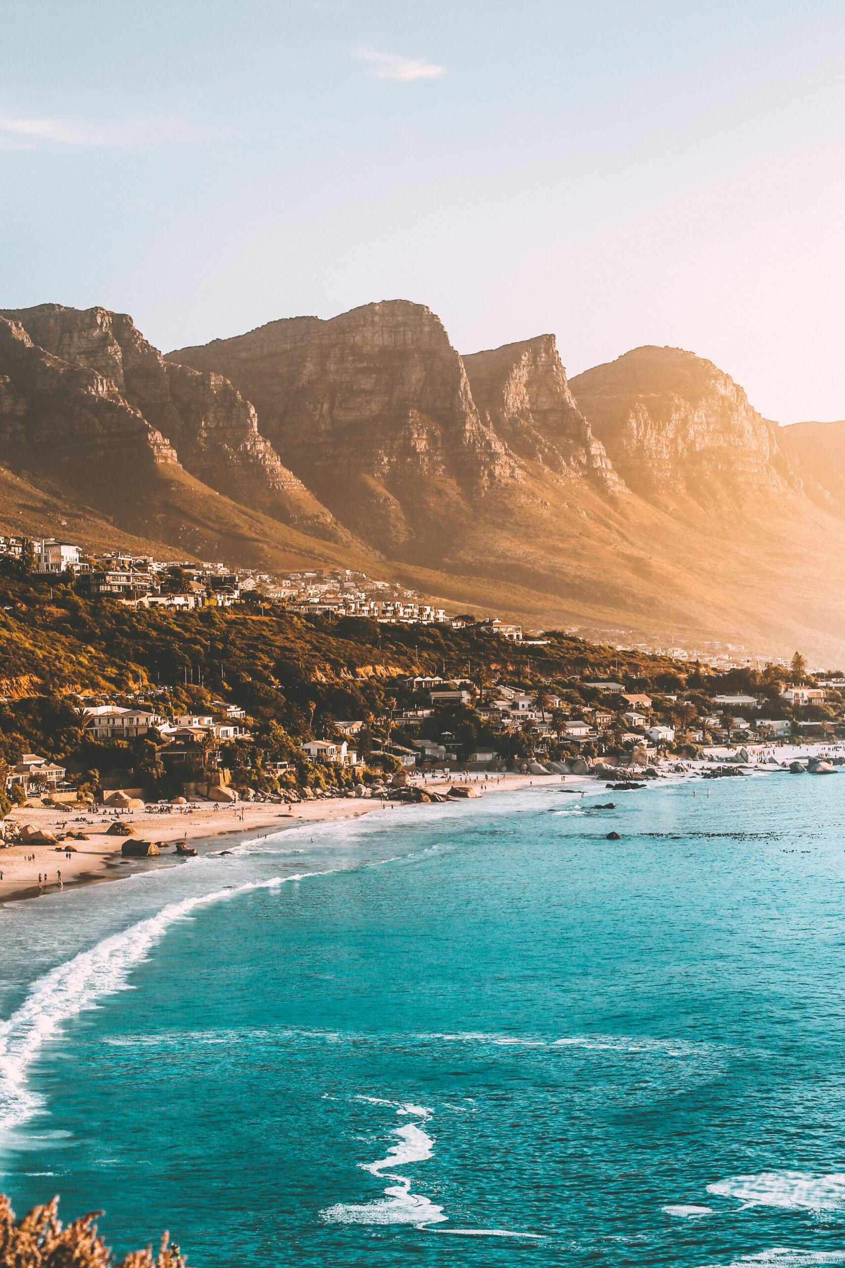 the ocean at camps bay with the twelve apostles mountain peaks in the background