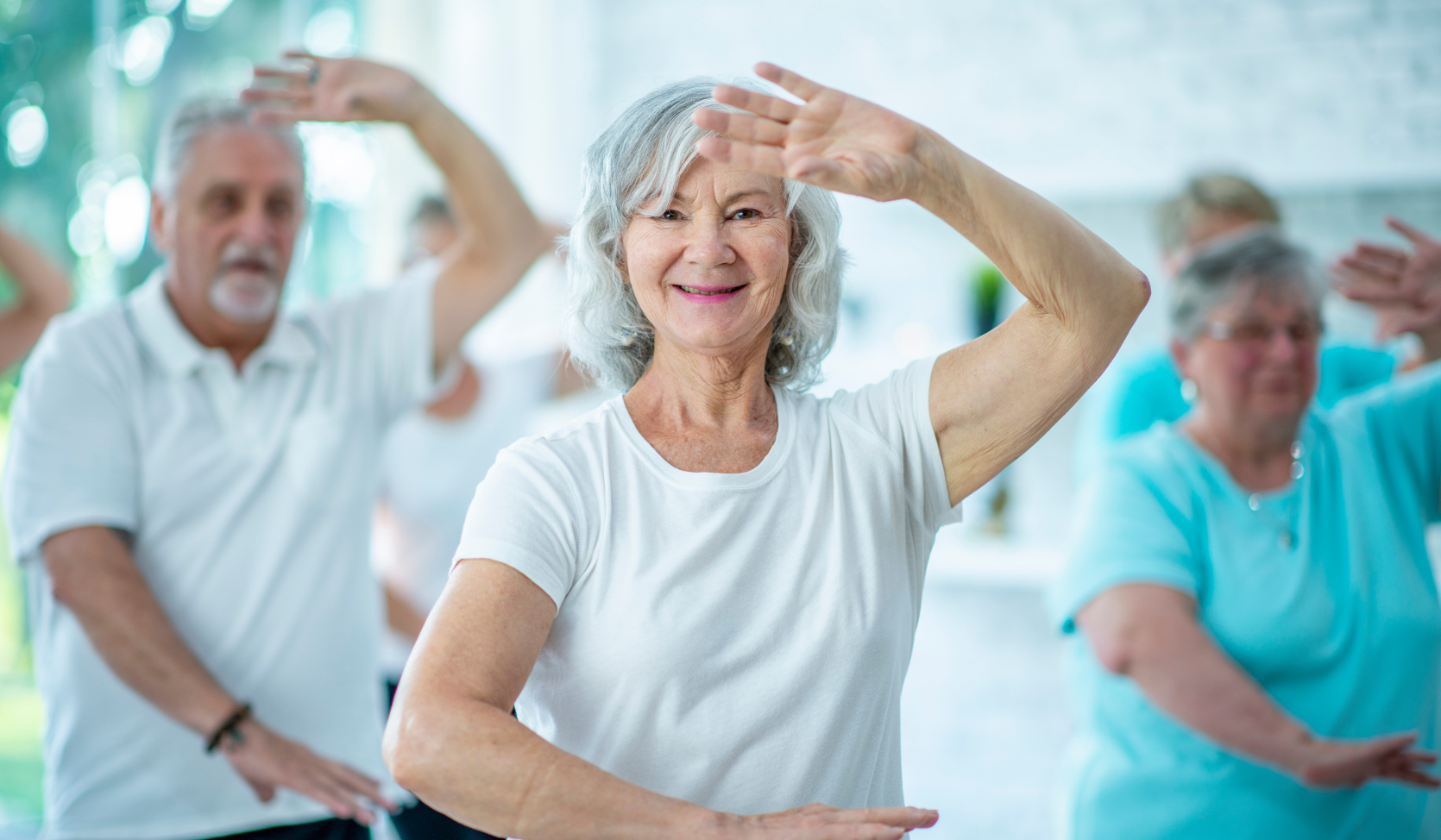 An image of an older woman practicing Tai Chi. 