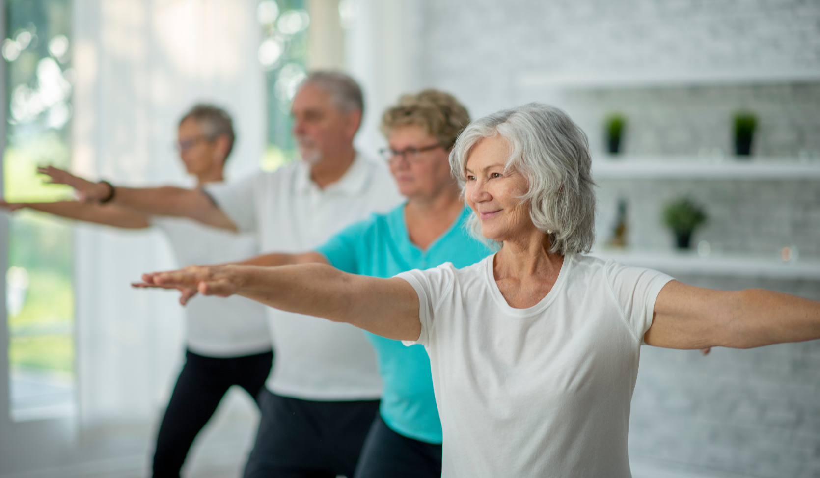 An image of a group of seniors practising Tai Chi in a studio