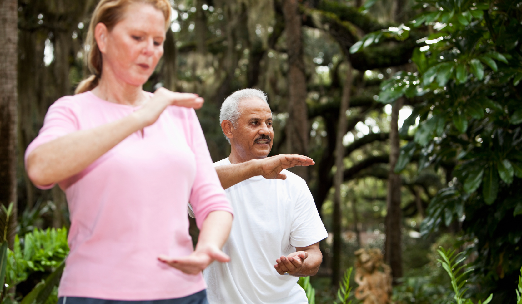 A cropped image focuses on hand positions during a Tai Chi workout.