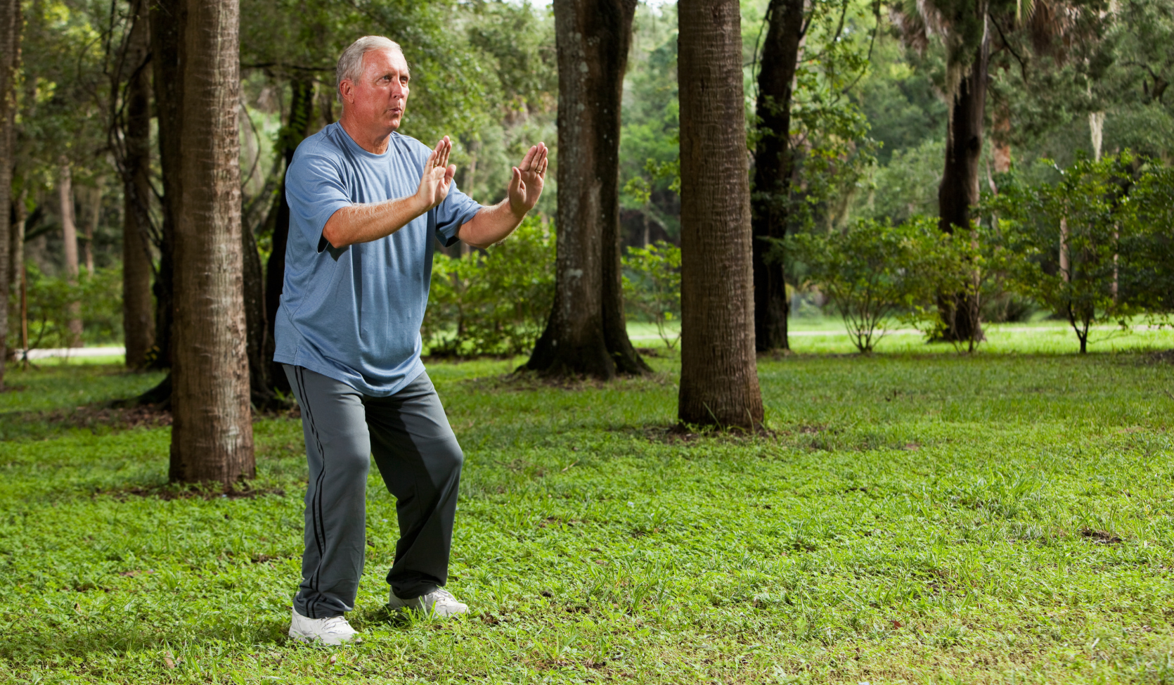 An image of a senior man in a Tai Chi stance.