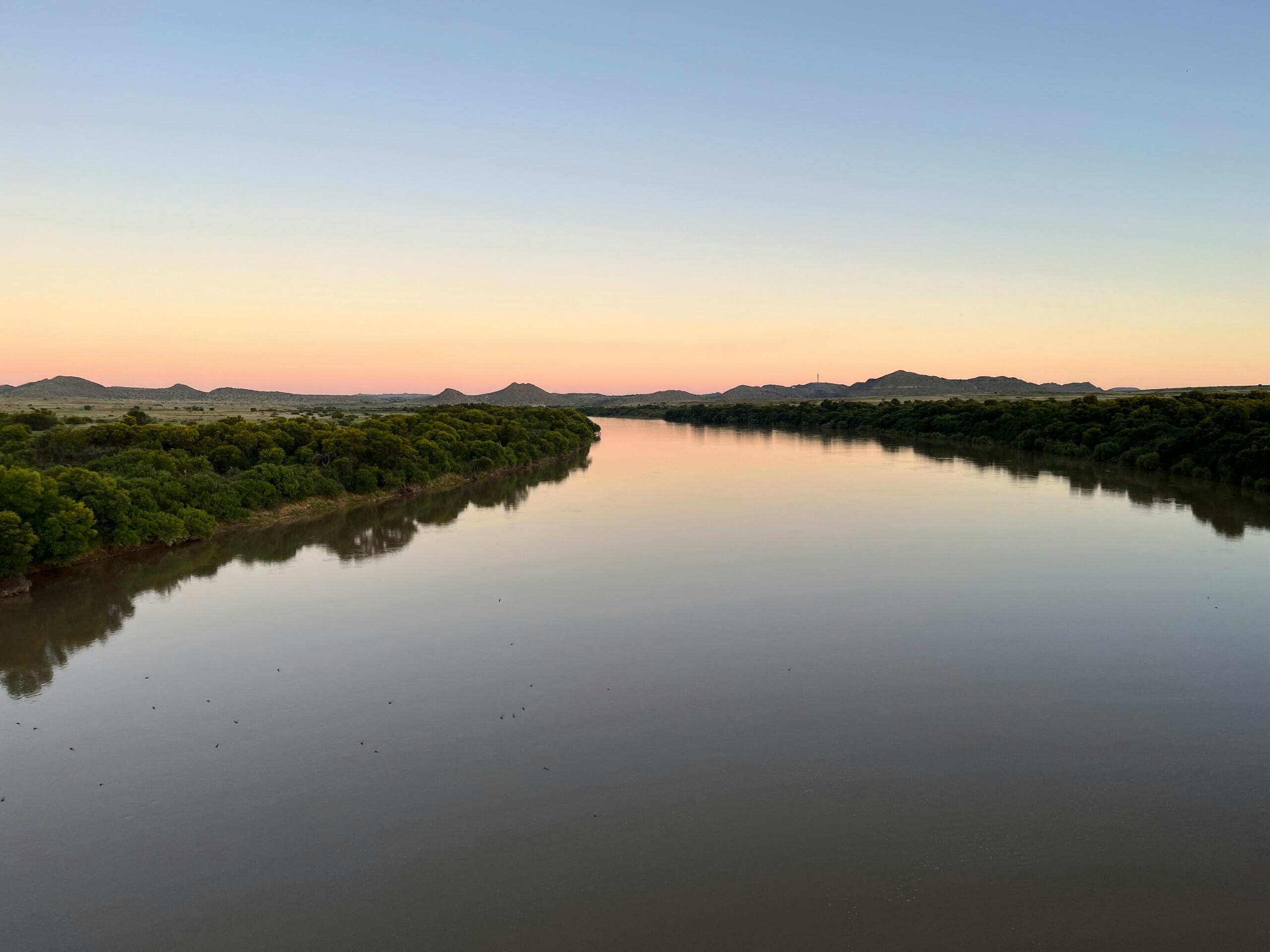 An image of a river at sunset. 