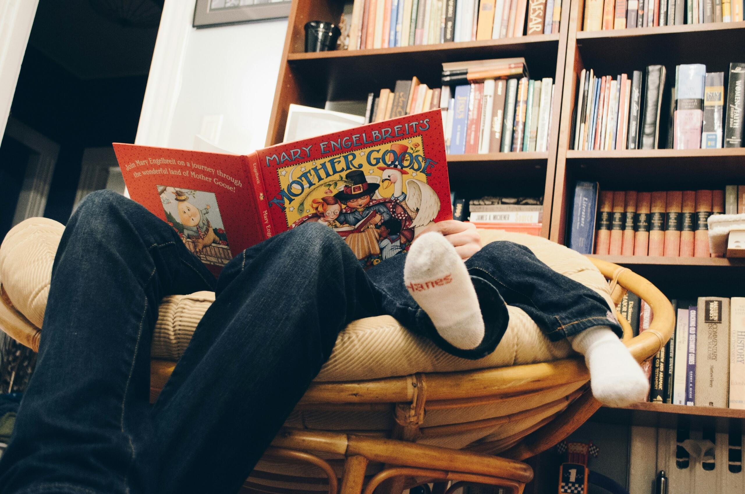 man-and-child-sitting-on-moon-chair-reading-a-book